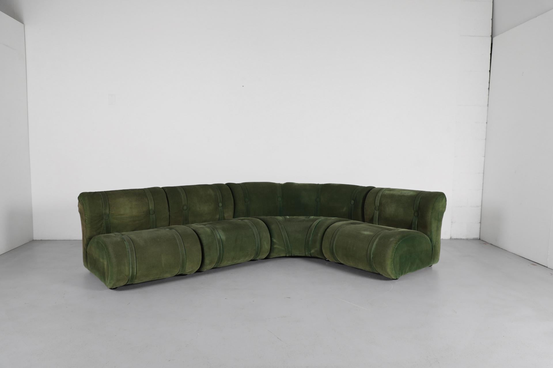 Doimo Salotti attributed sectional sofa commands attention with its rich olive green faux suede upholstery and distinctive modular design. Four-piece L-shaped configuration features channeled segments with decorative straps and button details,