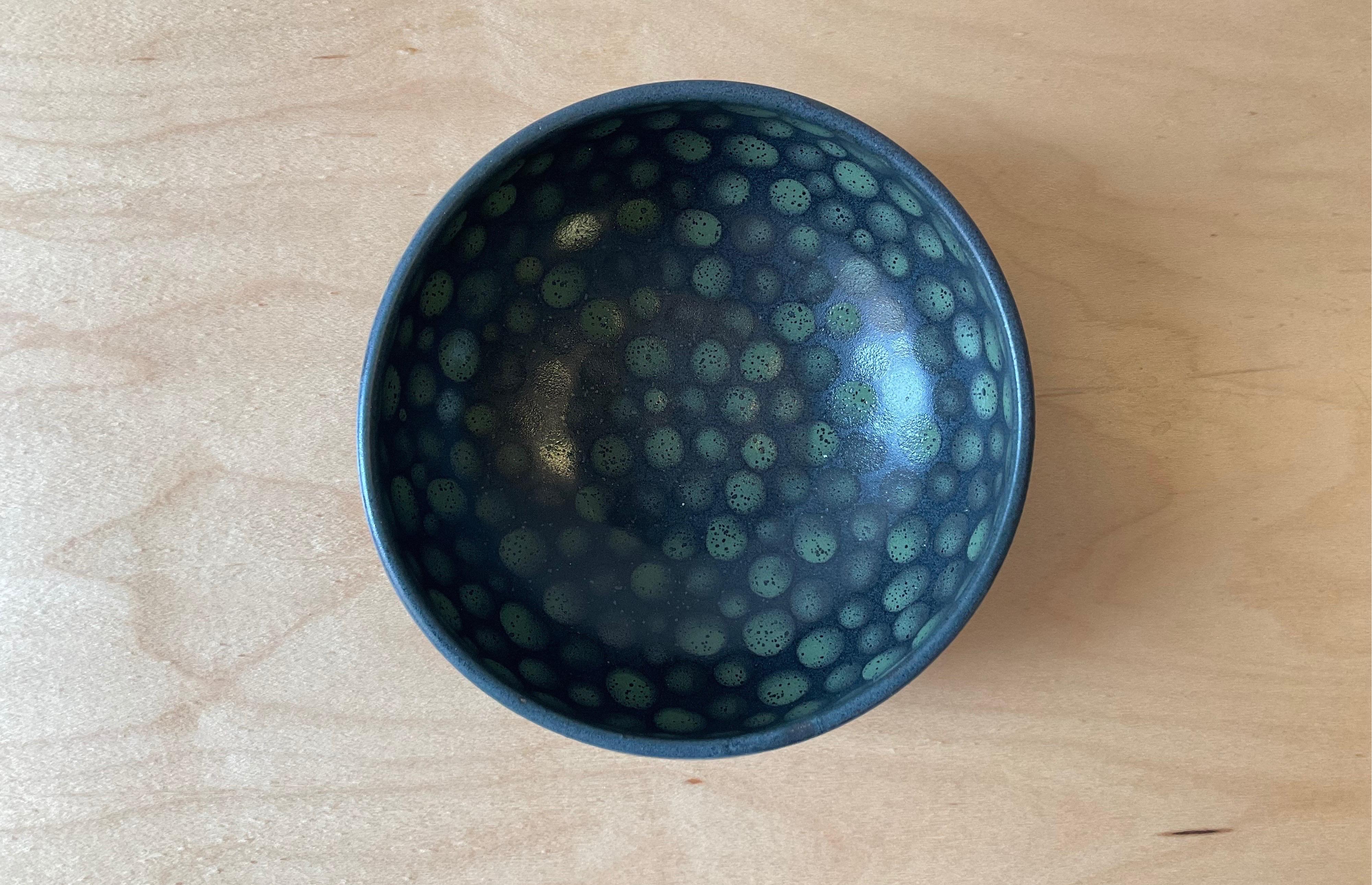 Small hand-thrown stoneware bowl. Green dots on black glaze. Measures: 4.5” x 4.5” x 2.5”

Made in Tribeca, NYC, by artist Lana Kova.
