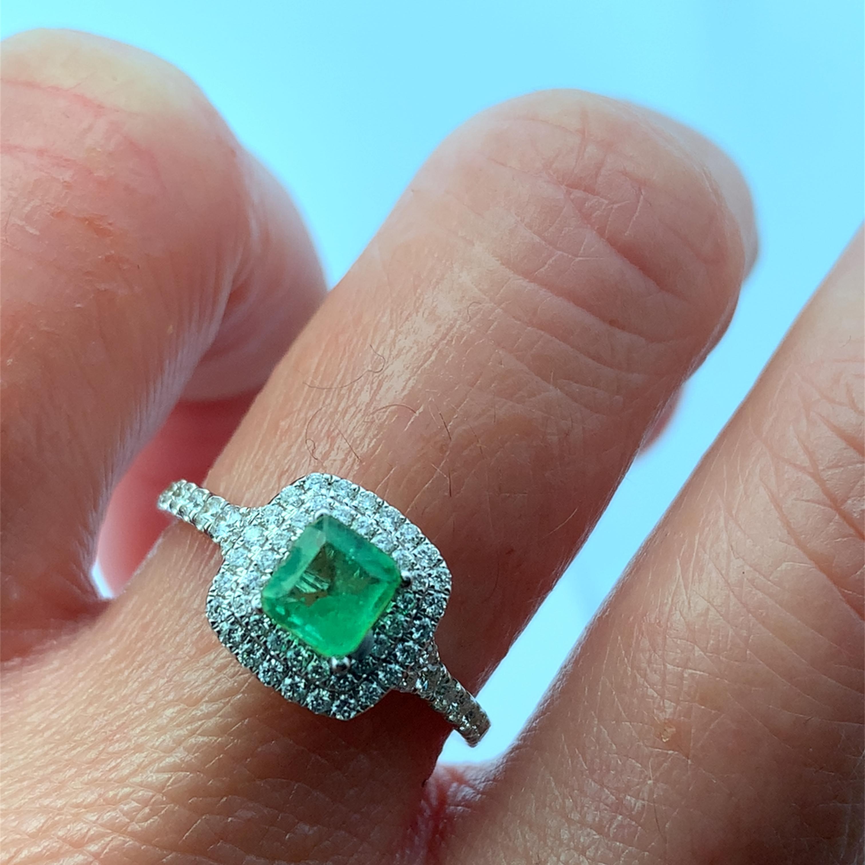 Discover the exquisite beauty of this green emerald and diamond double halo 18k white gold ring, a perfect blend of elegance and sophistication. The stunning green emerald 0.60ct is surrounded by a halo of sparkling diamonds 1.10ct F VS1, creating a