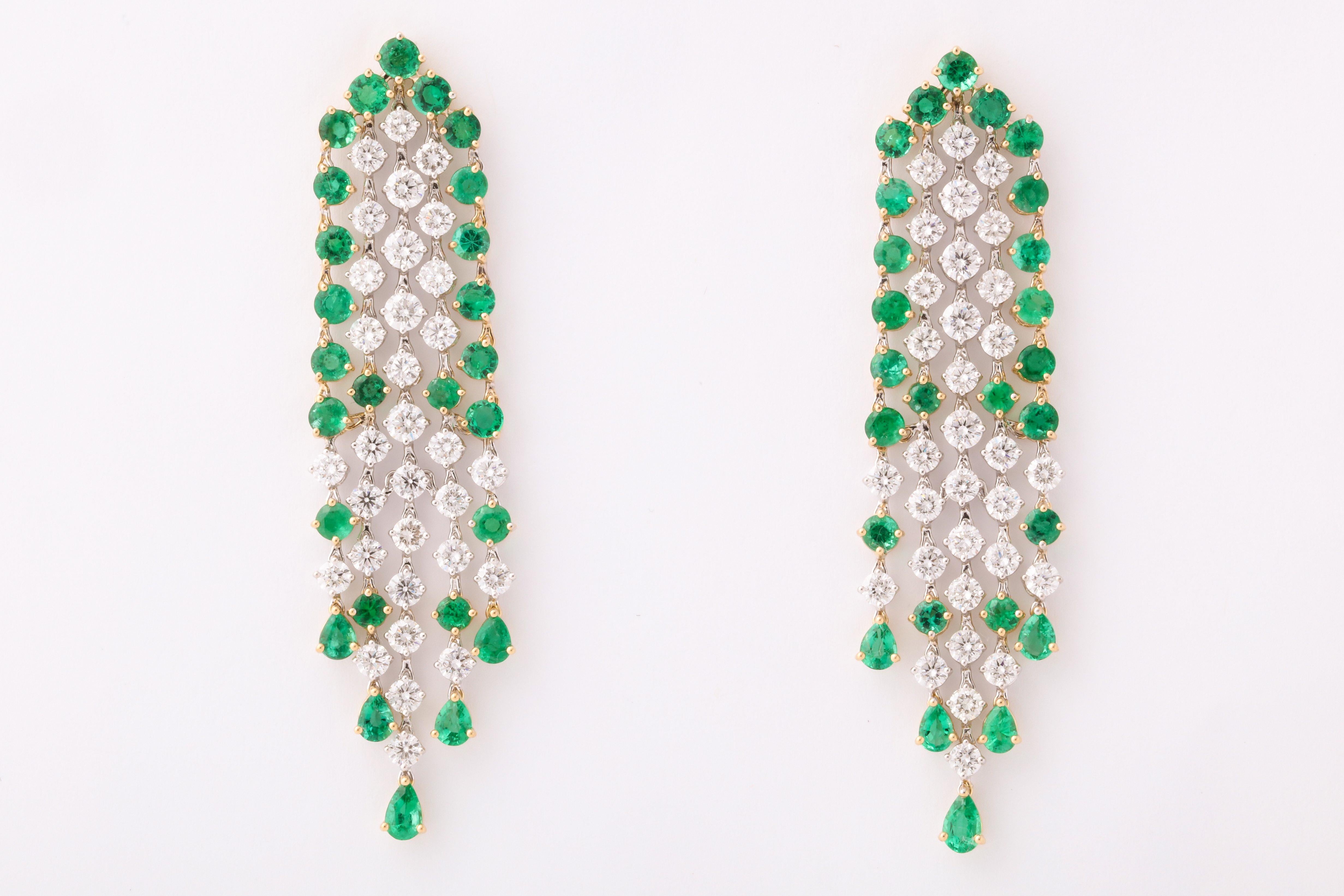 
An beautiful earring with fantastic movement.

6.19 carats of white round brilliant cut diamonds 

7.00 carats of fine vivid green round and pear shaped emeralds. 

18k white and yellow gold. 

Approximately 2.55 inches long and .60 inches wide. 