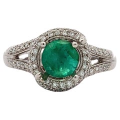 Green emerald and diamond engagement ring 18k white gold