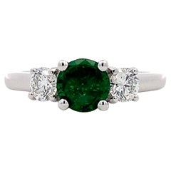 Green emerald and diamond trilogy engagement ring 18k white gold