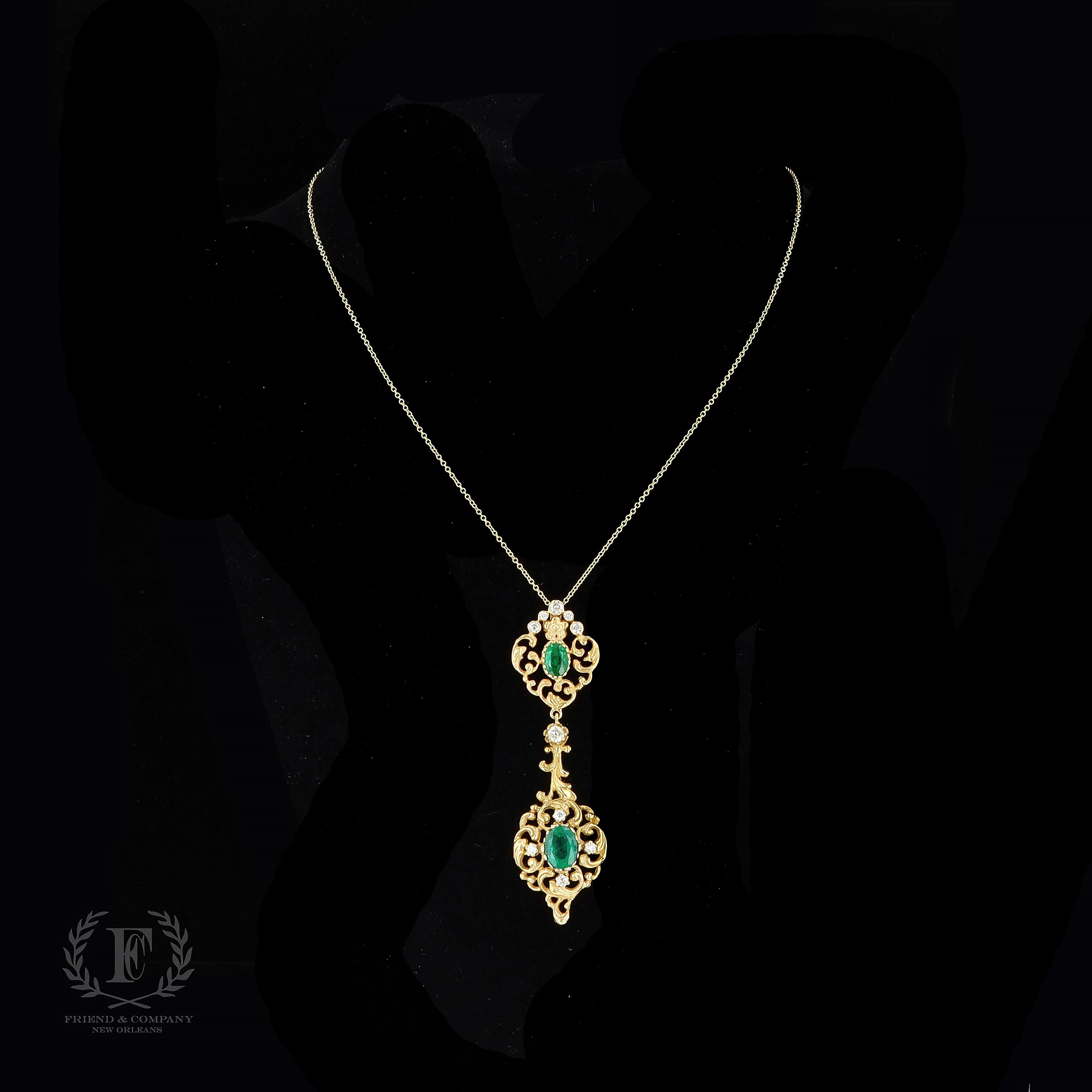 A necklace fit for a queen. This marvelous pendant necklace features oval cut green emeralds that weigh approximately 2.14 carats. The green emeralds are accentuated by old mine cut diamonds. The pendant measures 60 millimeters by 17.5 millimeters.