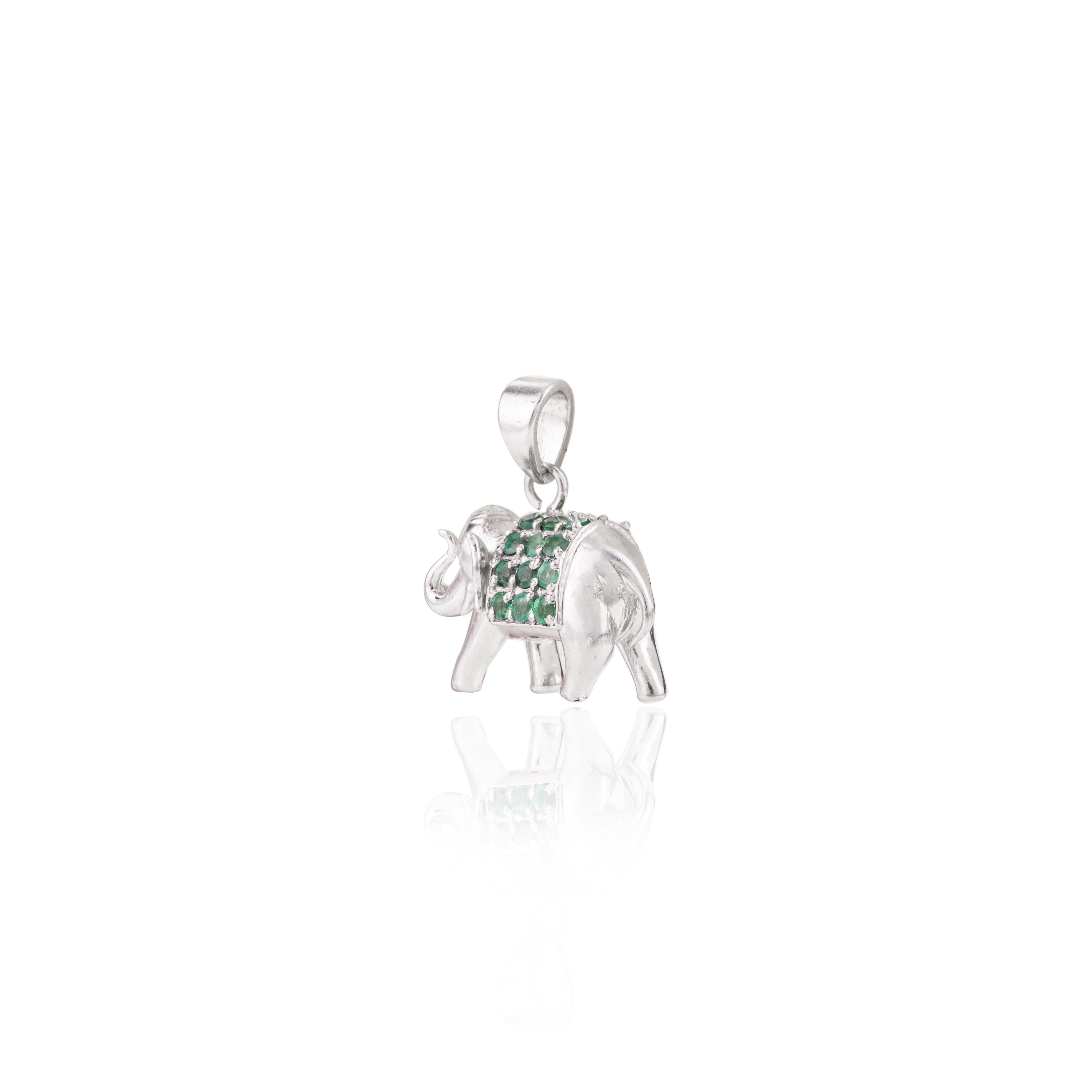 Green Emerald Birthstone Elephant Pendant in sterling silver studded with round cut emerald. This stunning piece of jewelry instantly elevates a casual look or dressy outfit. 
Emerald enhances the intellectual capacity of the person.
Designed with