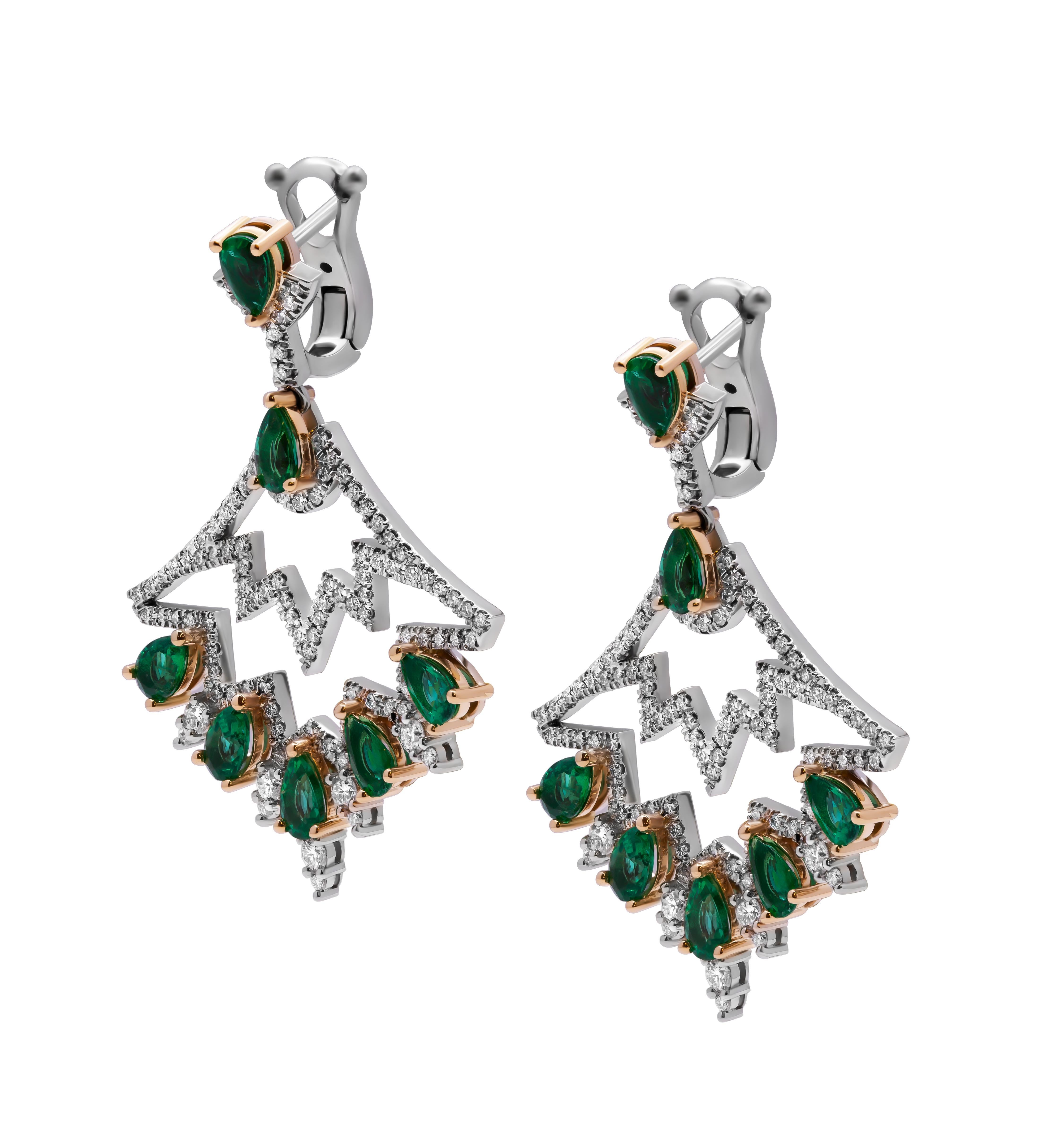 Experience the dazzling allure of luxury with these exquisite chandelier earrings, meticulously crafted in 18k white gold. These stunning earrings feature a captivating blend of green emeralds and white diamonds, creating a harmonious and elegant