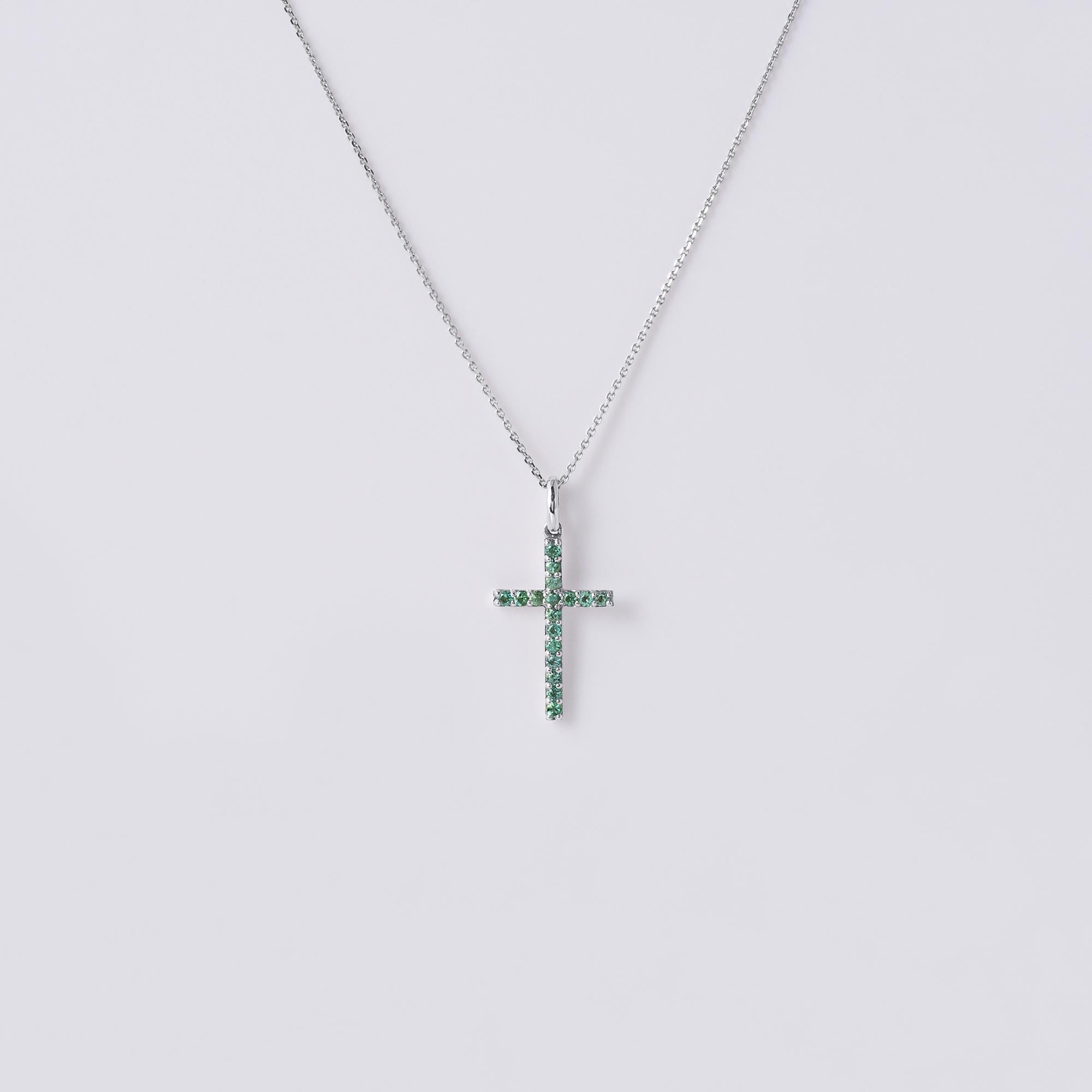 Modern emerald cross in 18k white gold
16 round green emeralds weigh ~0.13 carats
1.8 grams
18 inch chain, adjustable loop to shorten.
.75inch length (with bale) x 0.3 inch width