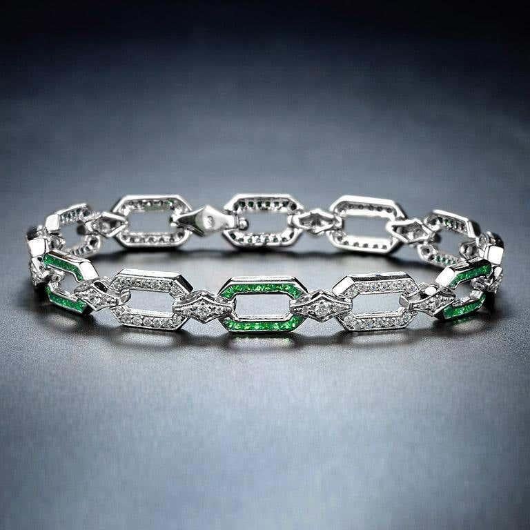 A captivating design that combines the elegance of emeralds and the brilliance of diamonds. Set in an Art Deco style, the bracelet showcases alternating emeralds and diamonds link, creating a timeless geometric pattern that adds both sophistication