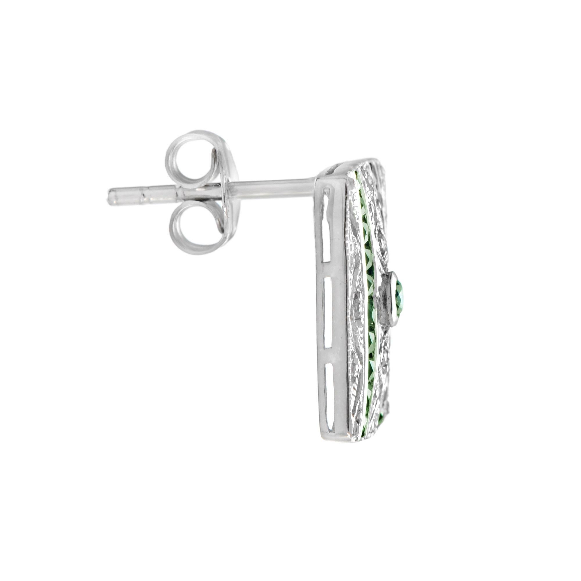 A beautiful pair of Art Deco style 14k gold millgrain and open work square shape stud earrings featuring 2 round and 40 French cut emeralds with total of 0.06 carats diamonds. These simple and classic earrings are perfect to wear anytime. White