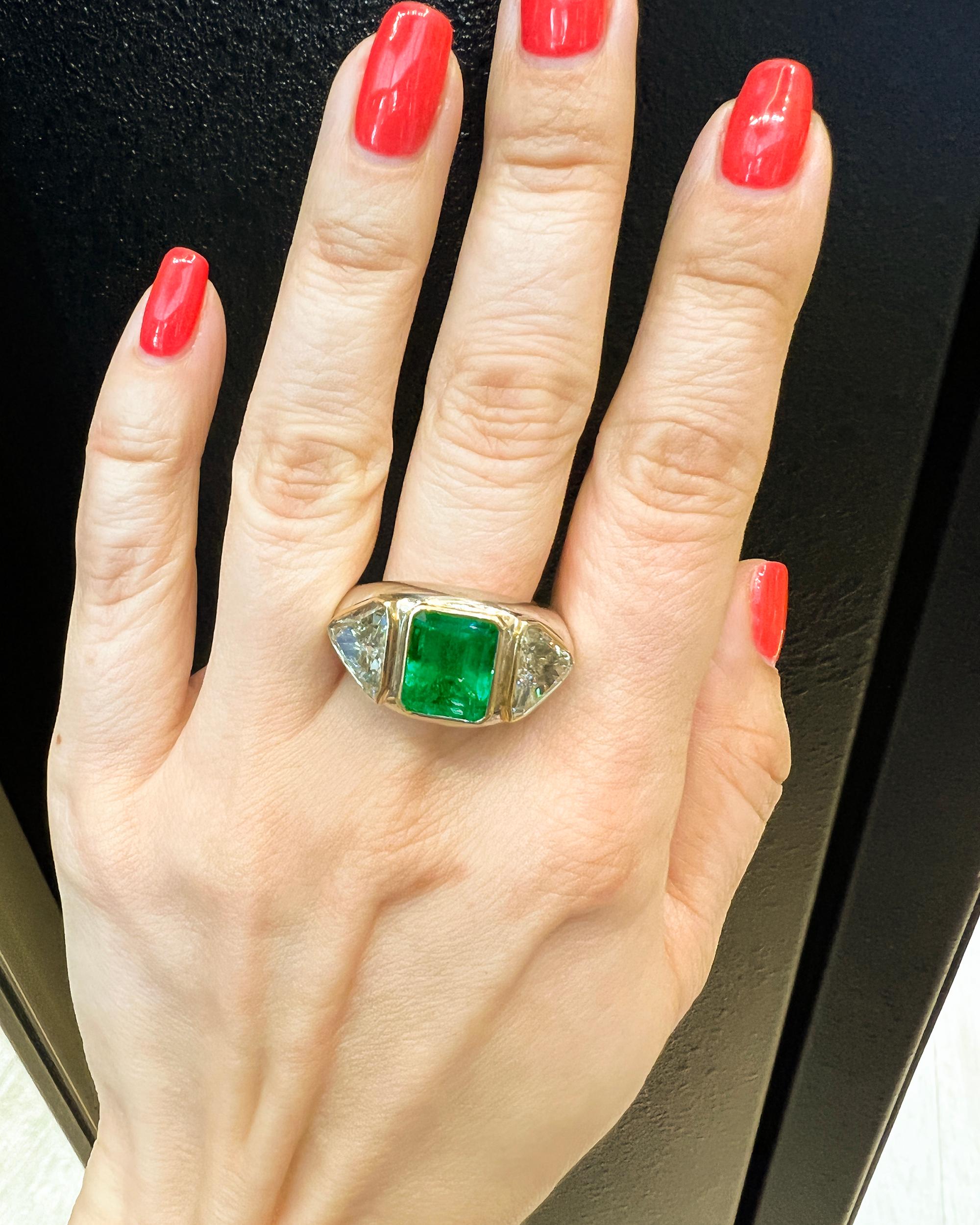 What could be bolder than this Art Deco-inspired emerald jewel, equally stunning as a cocktail or engagement ring, with fabulous diamond shoulders? With its wide band and statement-making qualities, the cigar band ring is a popular style for
