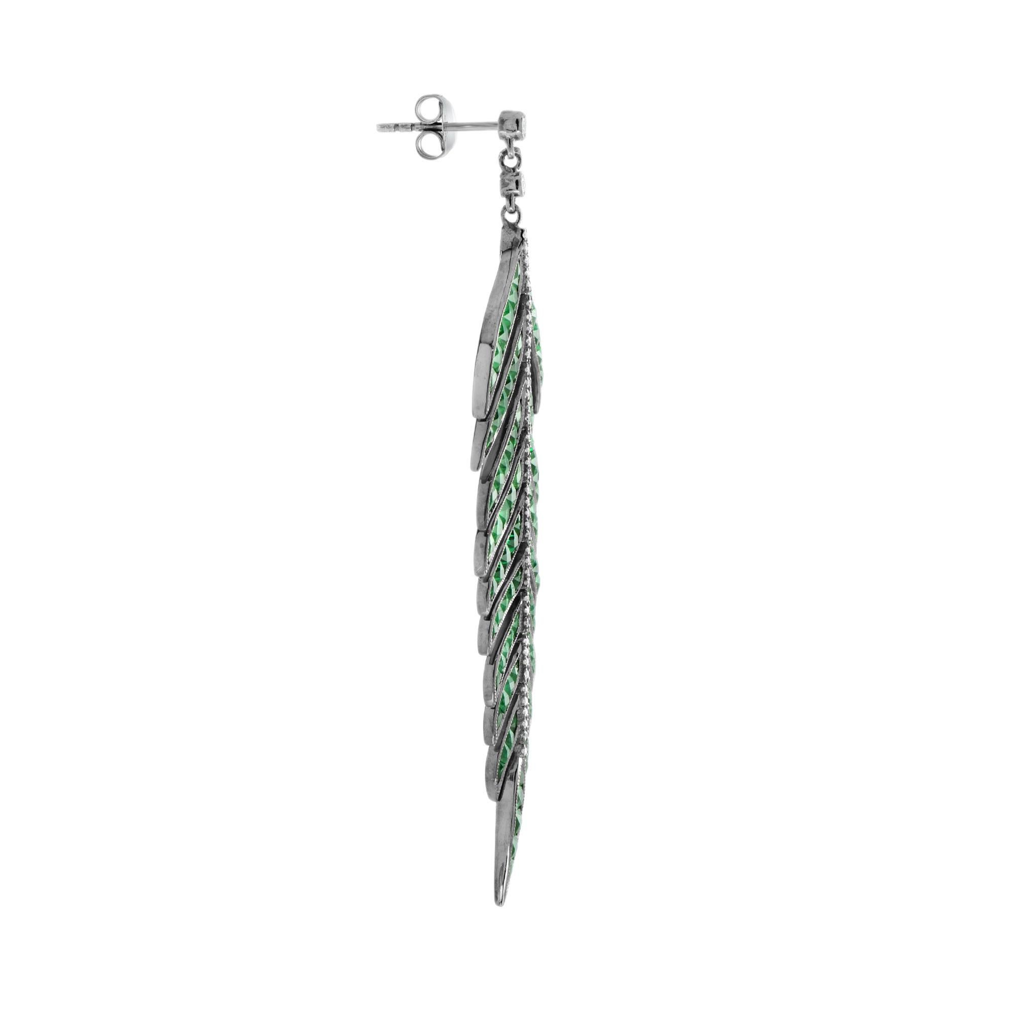 Dress up her ears in nature inspired elegance with these sophisticated green emerald and diamond leaf drop earrings. Crafted in black rhodium plating, each earring showcases an inspiring open design shimmering with emeralds total 15.1 carats and 0.5