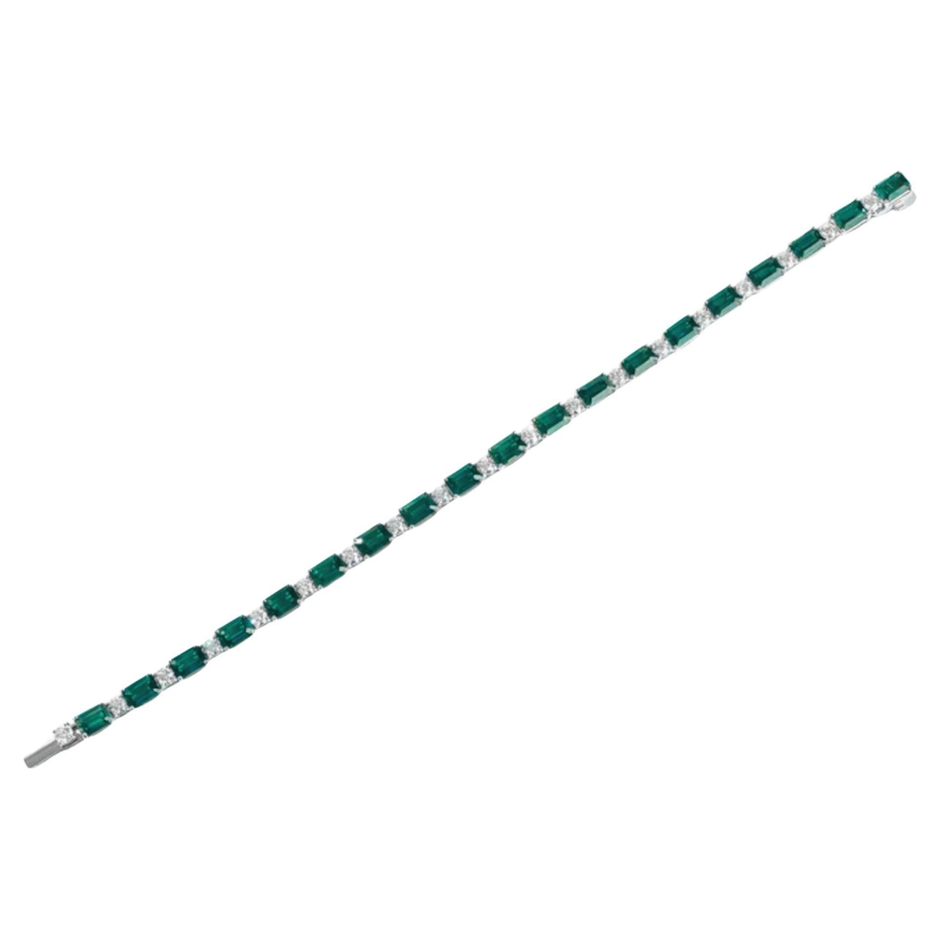 Emeralds and diamond 

Gemstone Type: Emerald-Cut; Number of Gemstones: 19
Weight of Gemstone: 13
Number of Diamonds: 19
Weight of Diamond: 2
Platinum is the metal.