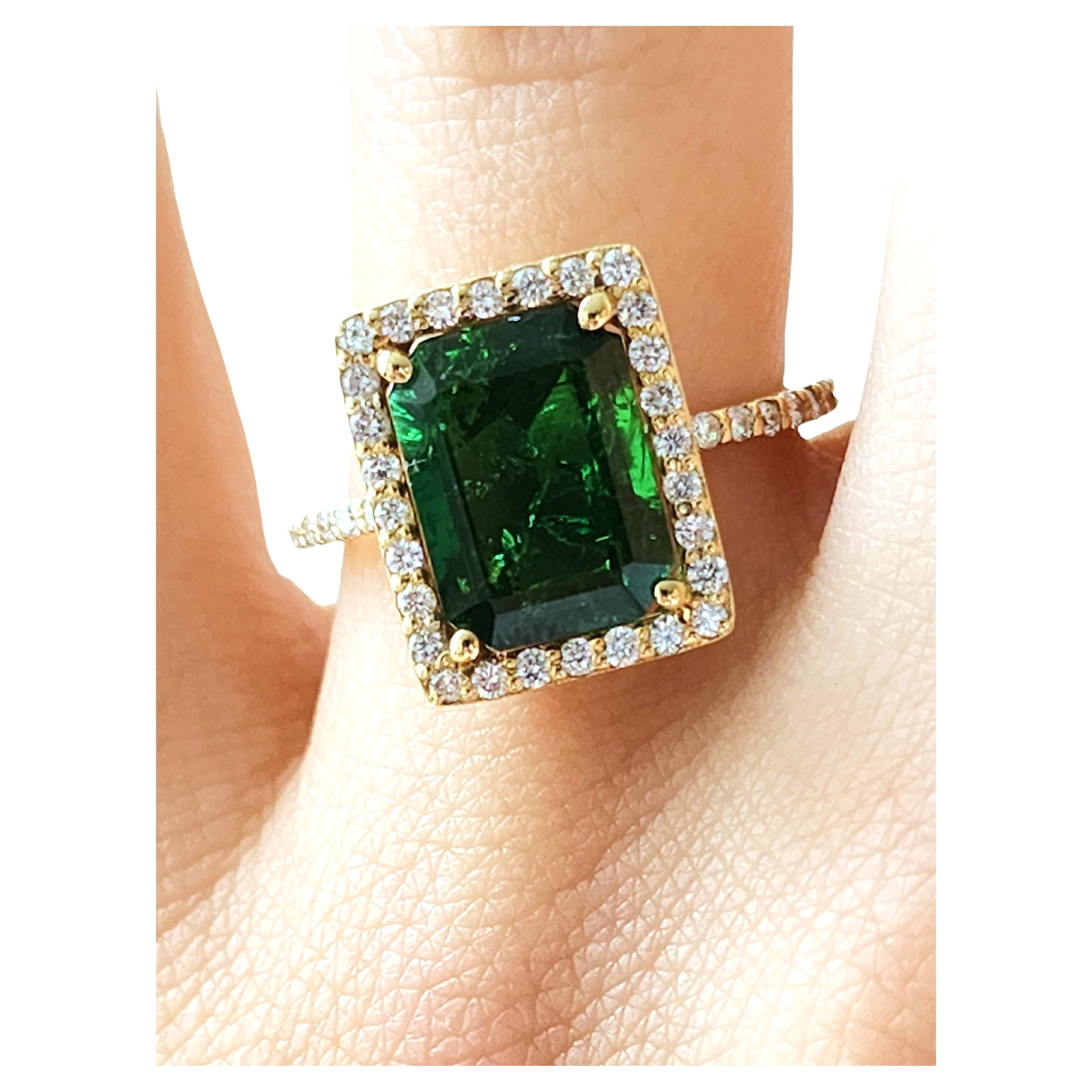 Set around beautiful small Round Diamonds including sidestones along the ring (Total Weight 0.4 Carat), sits an intense Green Emerald (Total Weight 3.7 Carat) in 14 K Yellow Gold. A unique ring fit to upgrade any outfit or occassion this season! 