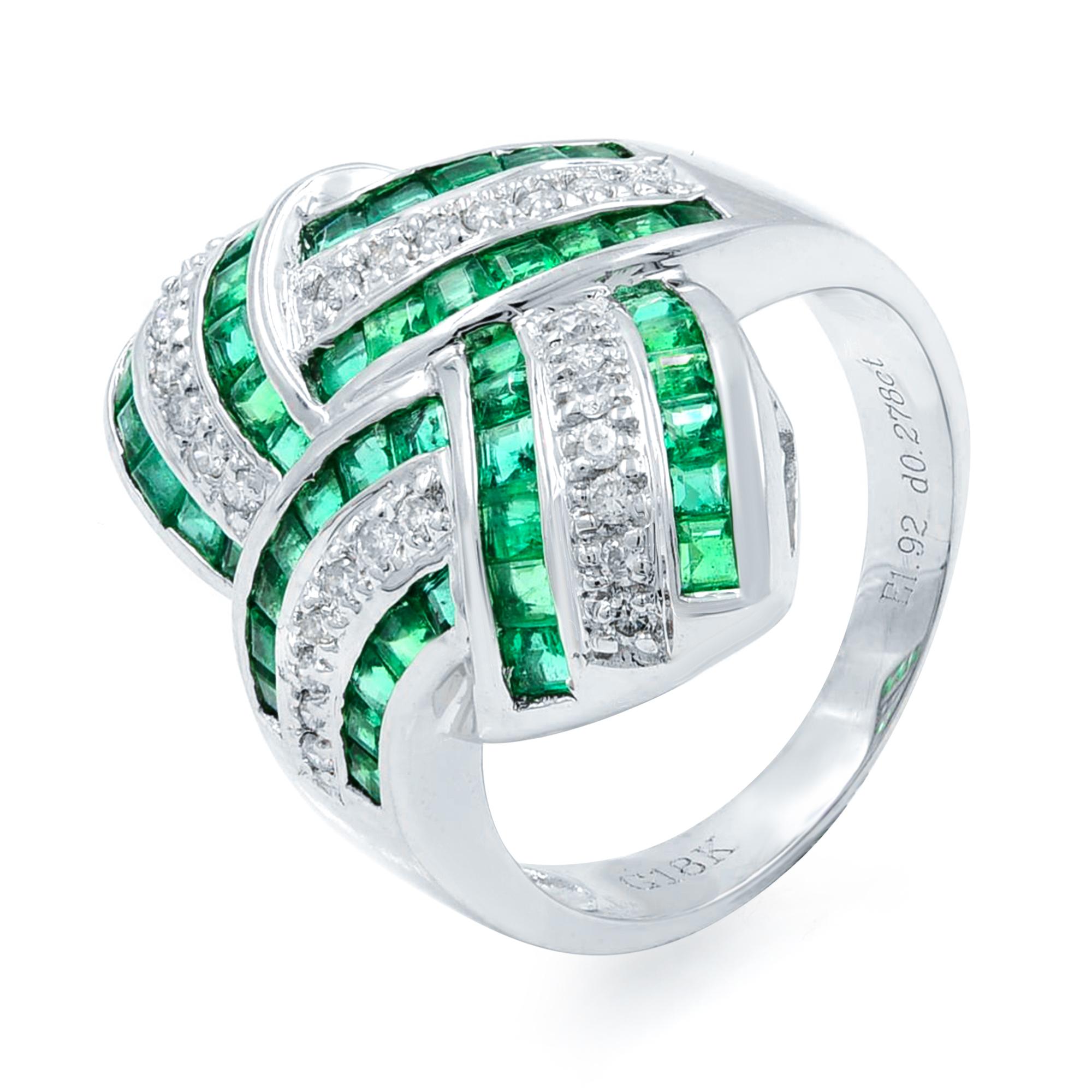 This sleekly styled modern band ring flashes around the top half with rows of bright, seamlessly-set square-cut emeralds bordered by seamlessly-set vibrant diamonds. A blazingly beautiful and impressive estate jewel, sturdily crafted in gleaming 18k