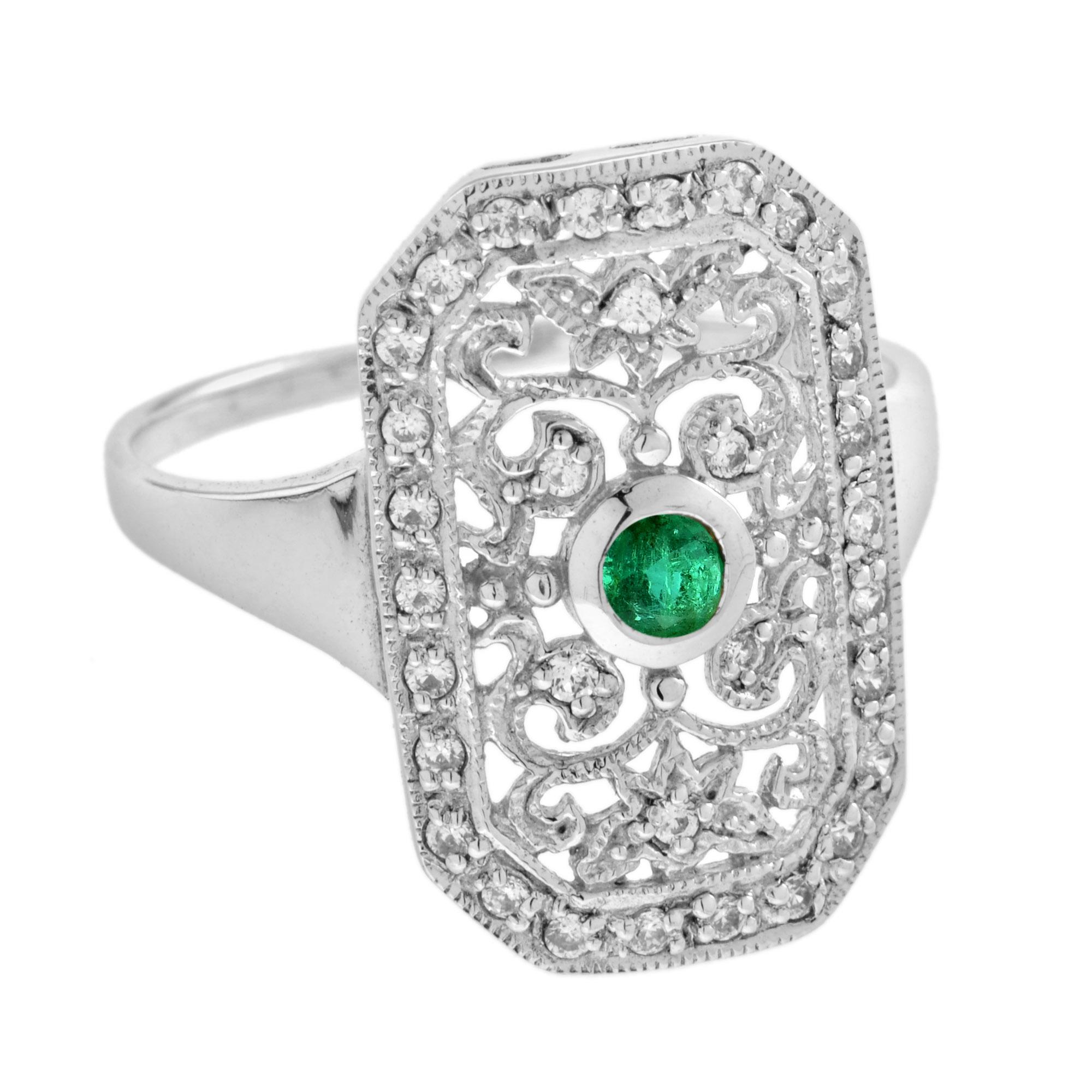 Featuring a 0.12 carat emerald at the center and an ornate, vintage inspired design, this ring is fit for any outfit. The colorful center stone is accent by sparkling round cut white diamonds that total to 0.21 carats set on white gold floral