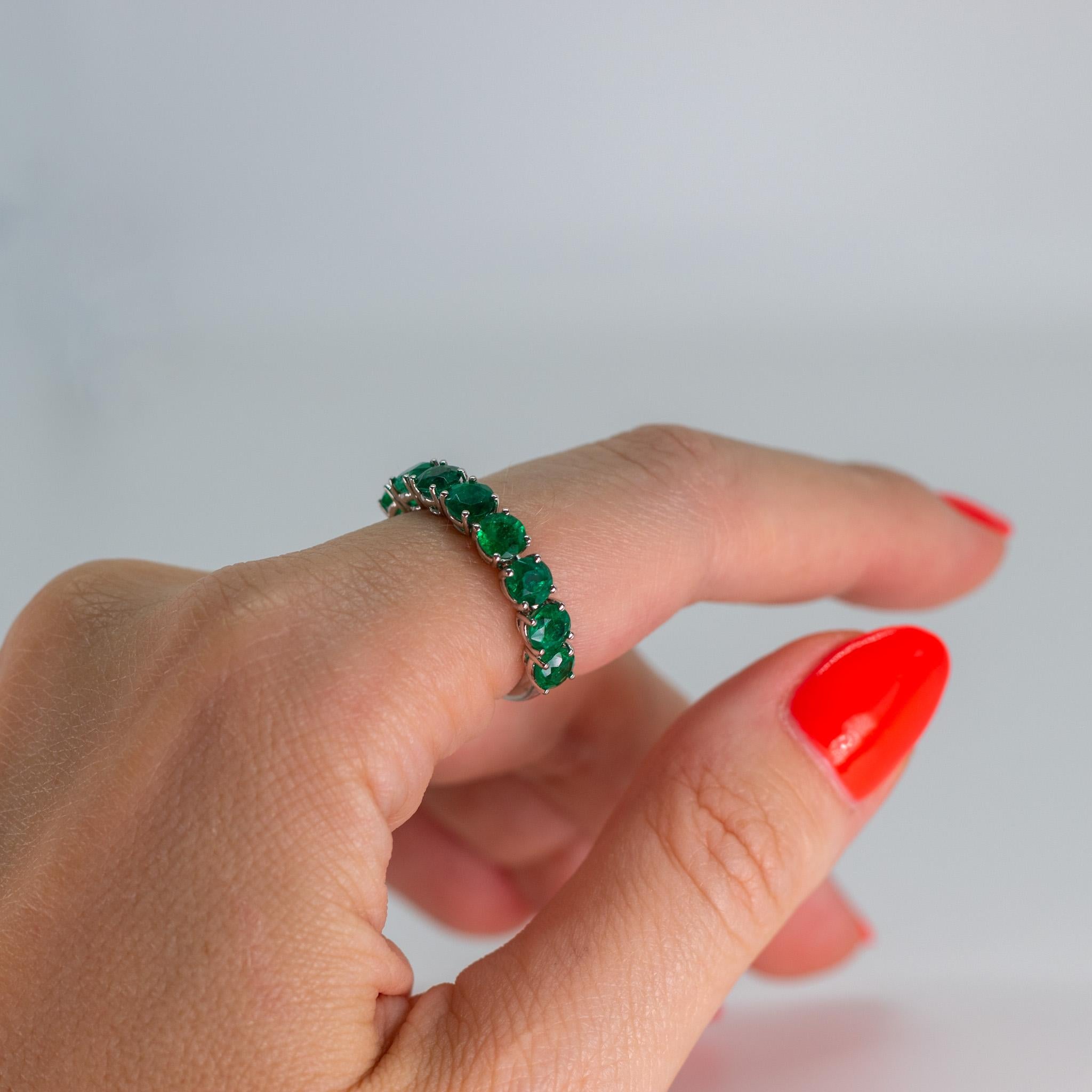 Beautiful Zambian green emerald eternity ring featuring 8 round natural emeralds set in a platinum ring.

Emeralds are said to bing good fortune and good luck to the wearer, and to attract wealth. In addition, emeralds are believed to attract
