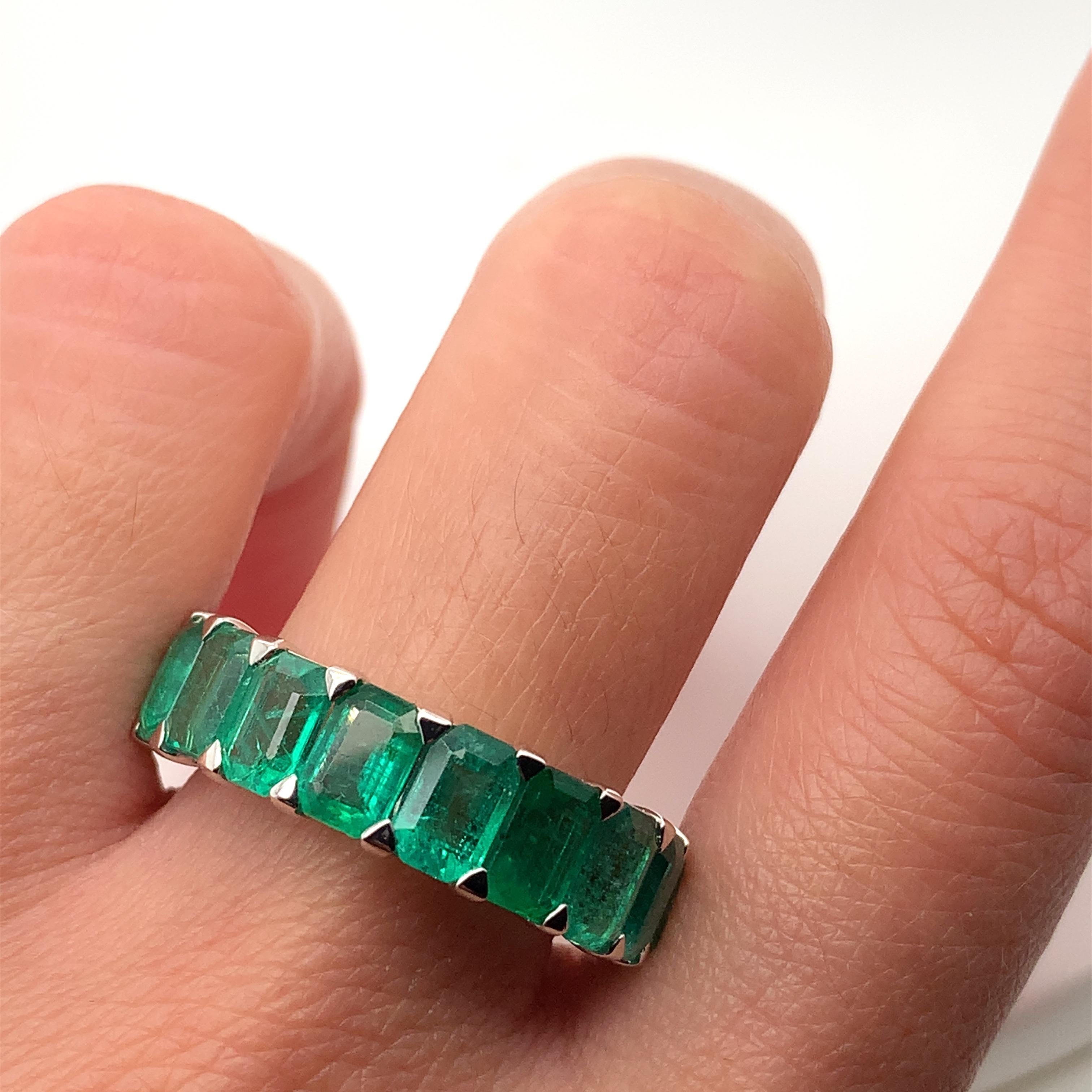 Indulge in luxury with this exquisite 7.16ct Green Emerald Full Eternity Cocktail Ring. Crafted from 18k white gold, this solitaire ring features a stunning emerald-cut main stone. Its elegant design and artful theme make it perfect for special