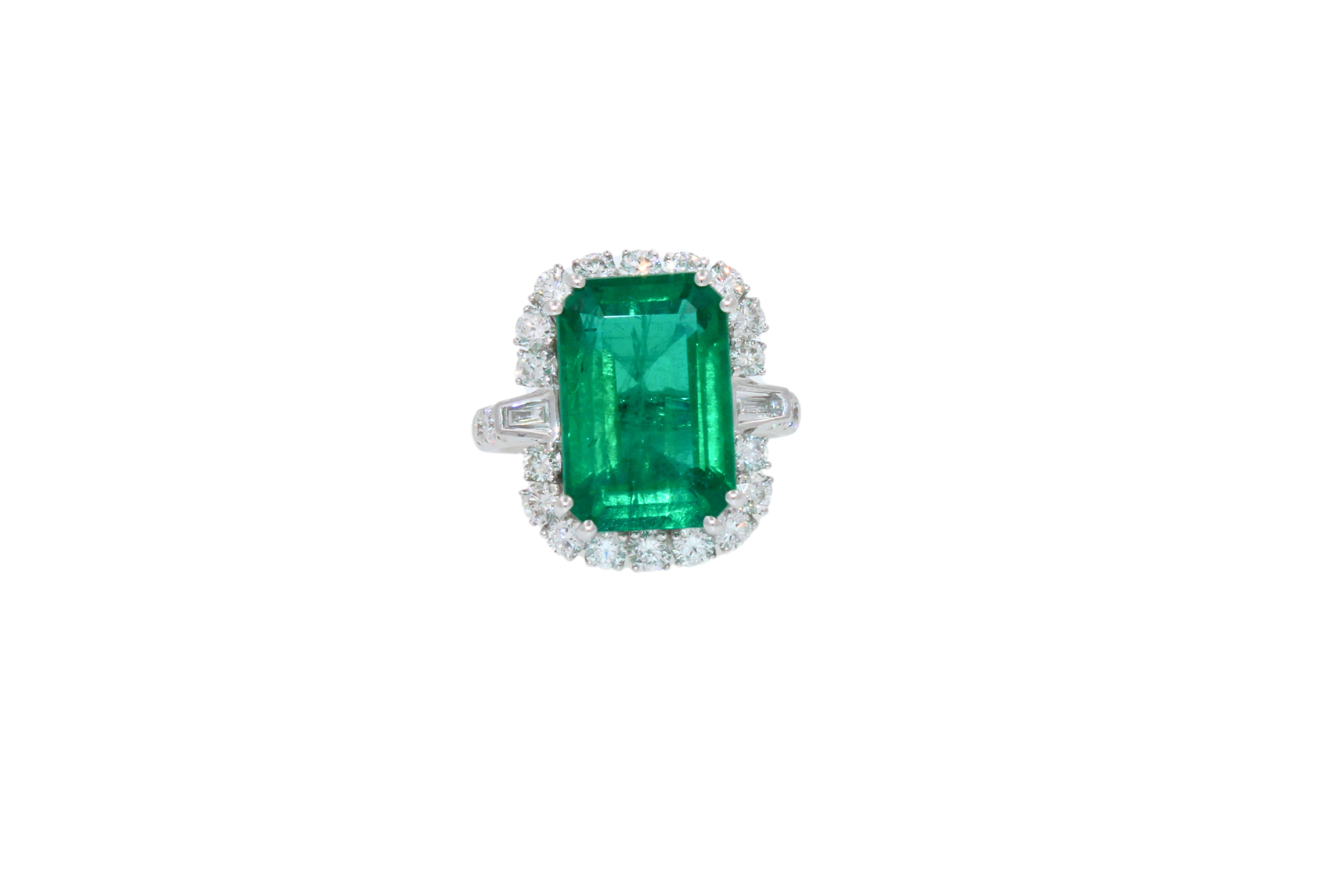 9 CT Emerald Shape, Genuine Emerald
14.62 x 8.82 mm length width ratio of center Emerald
8.75 Grams
18K White Gold
2.0 Carats of White Diamonds F/VS Quality Grades
6.25 Size