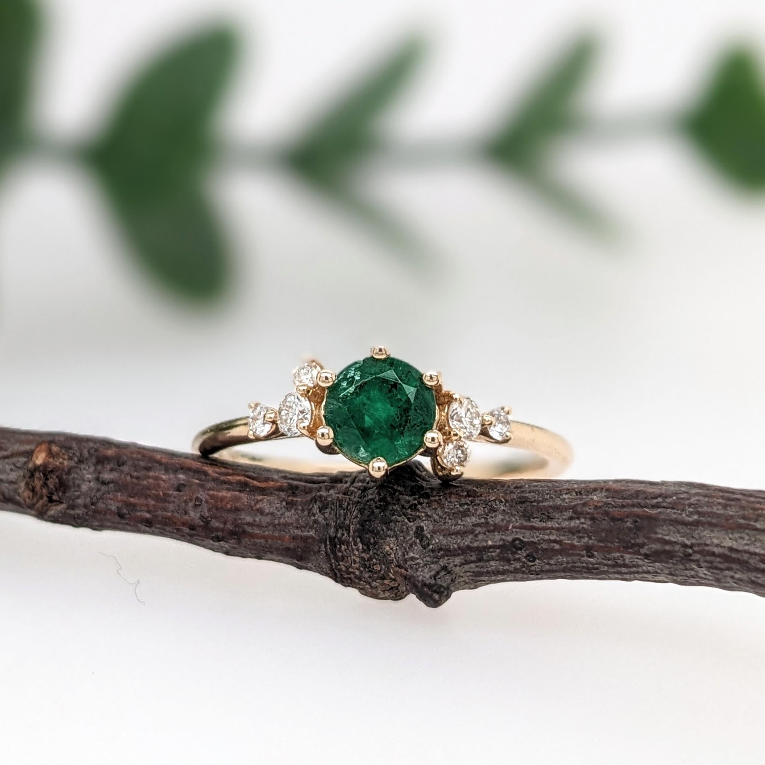 A simple dainty ring perfect for the minimalist in your life or for giving someone their first piece of jewelry :) This emerald presents a mixture of green hues which is perfectly accentuated by diamonds on each side. The slim yellow gold shank