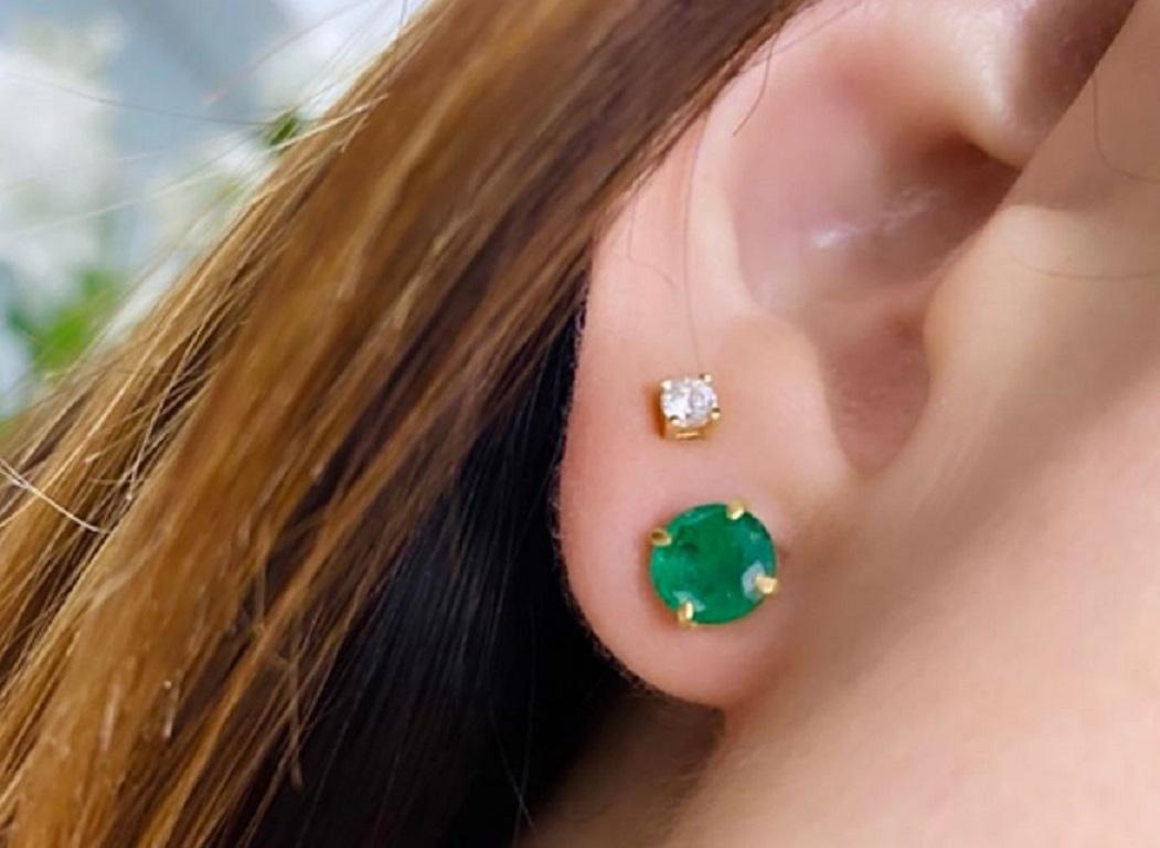 Simple and chic, these natural emerald stud earrings add color to any style. Fashioned in warm 18K gold, each earring showcases a 6.6 mm verdant-green emerald solitaire. Polished to a bright shine, these post earrings secure comfortably with screw