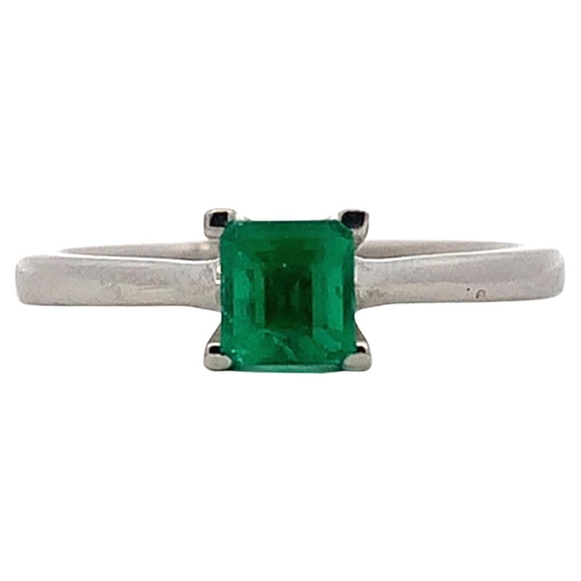 Green emerald solitaire engagement ring in 18k white gold