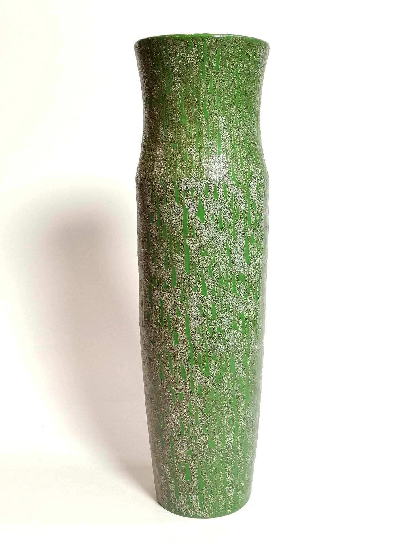 This vintage ceramic vase features an organic cracked pattern on top of the smooth emerald green surface. The vibrant yellow inside adds just enough warmth to its appearance, that begs for spring flowers to occupy this piece from the 1970’s 

This
