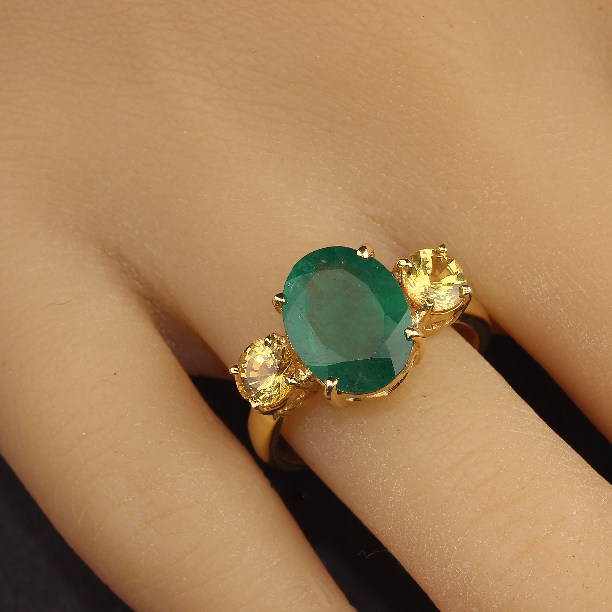 Striking dinner ring of large 3.11 carat oval Emerald accented with sparkling round golden Citrines, 1.3 carats total weigh. This setting is gold rhodium over Sterling Silver and a nice weight and width to balance the size of the gemstones.