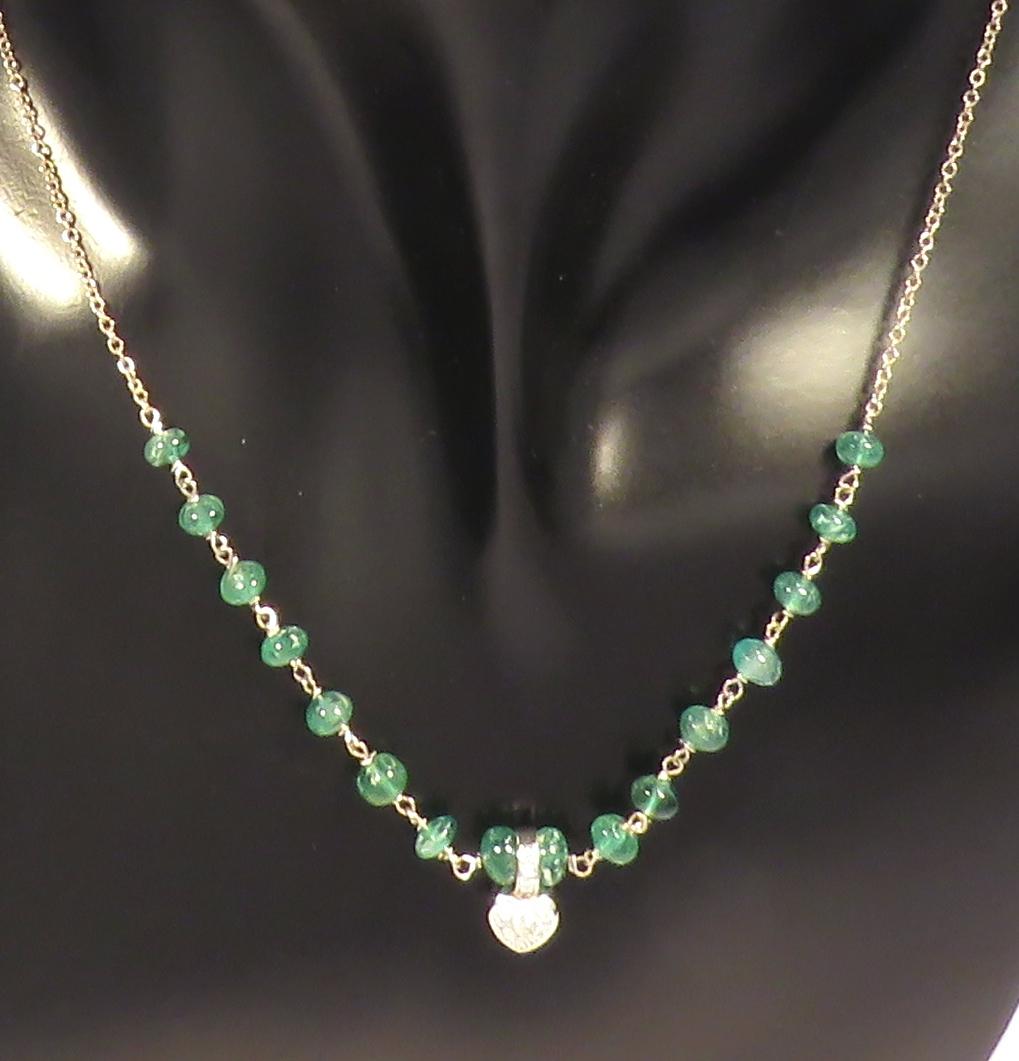 Beautiful necklace with genuine green emeralds and white diamonds set in a 9 karat white gold heart. The necklace length is adjustable from 410 mm to 440 mm / from 16.141 inches to 17.322 inches, it is possible to lengthen the necklace on customer's