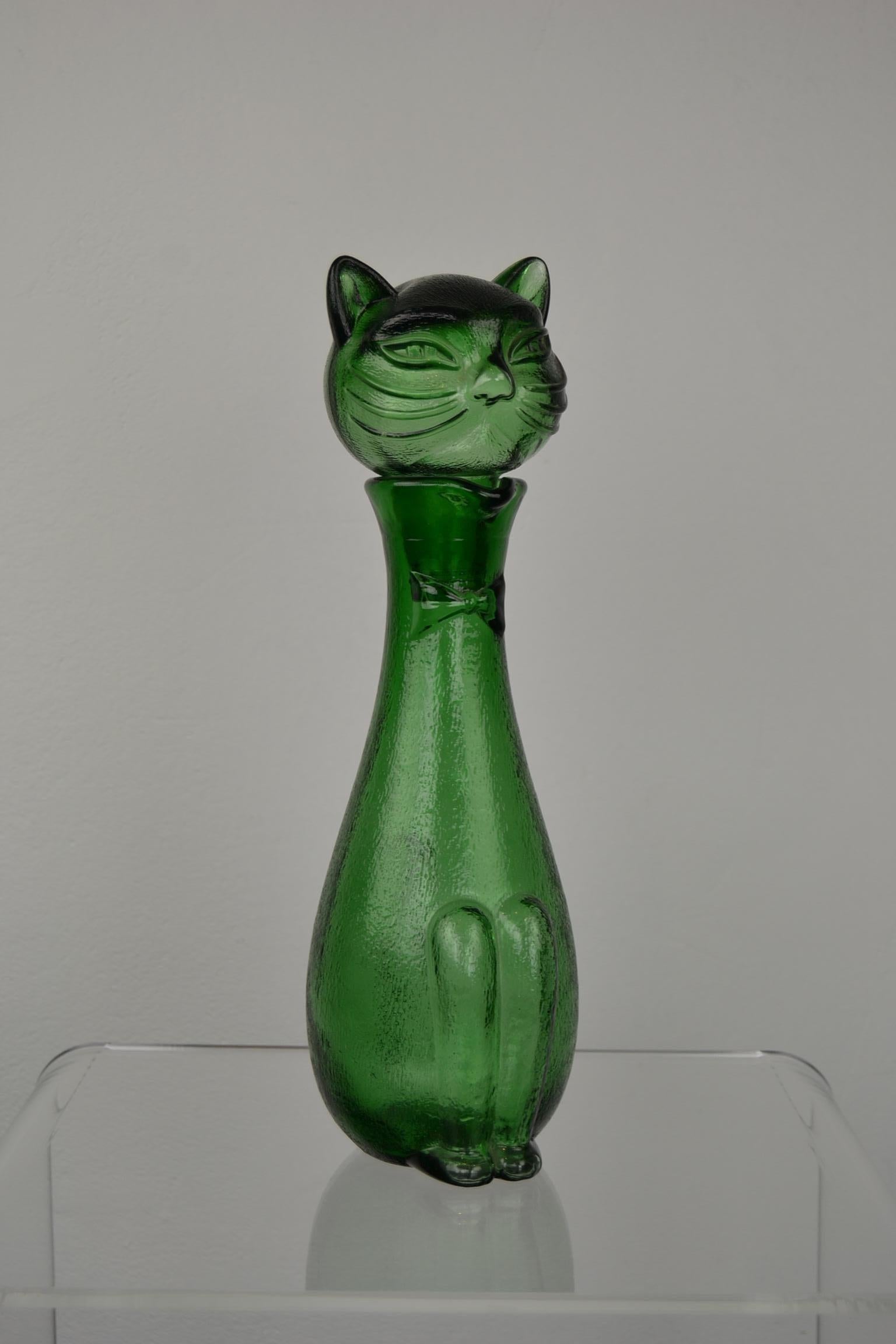 1960s glass cat decanter by Empoli Italy.
This emerald green glass decanter in the shape of a cat or cat bottle with stopper will look great in your interior.
 
   