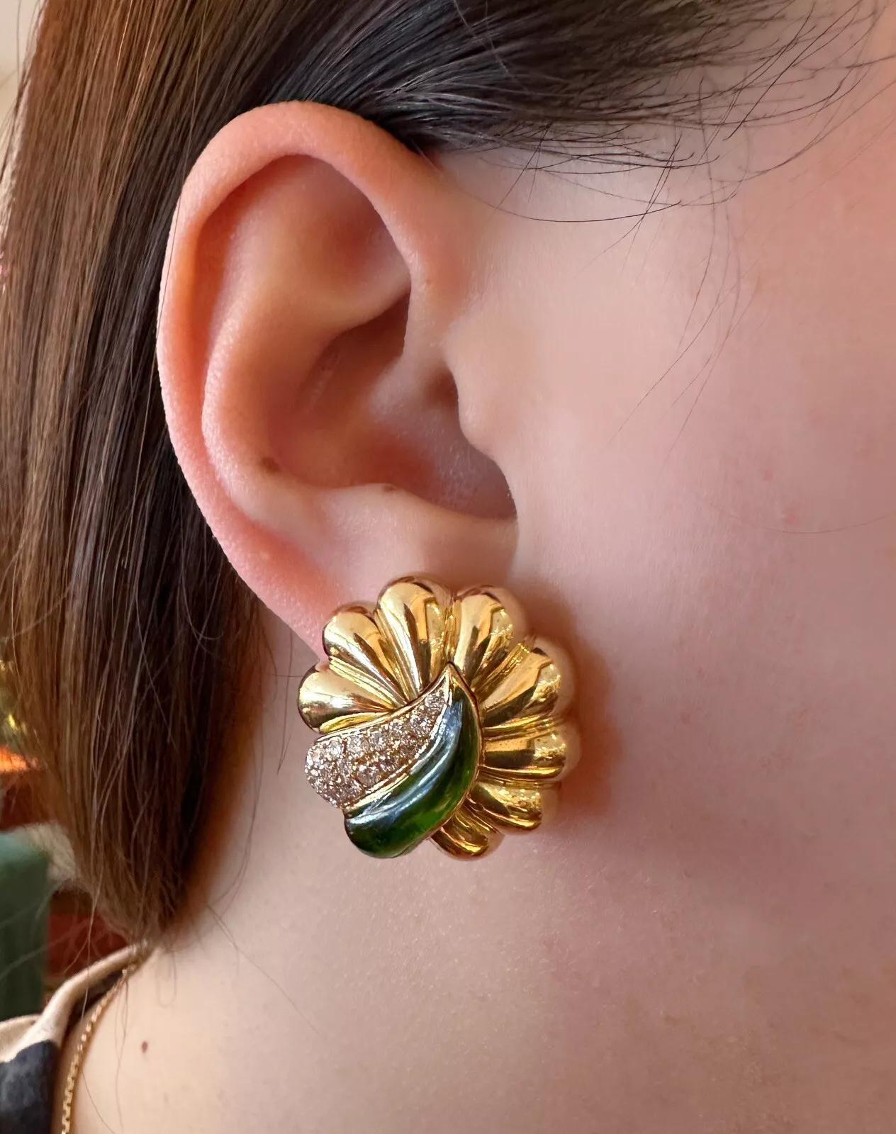 Green Enamel and Diamond Scallop Earrings in 18k Yellow Gold

Diamond and Enamel Earrings feature Round Scalloped Earrings with a Pave Diamond accent and a Green Enamel accent, all set in 18k Yellow Gold. The earrings are secured by posts with Omega