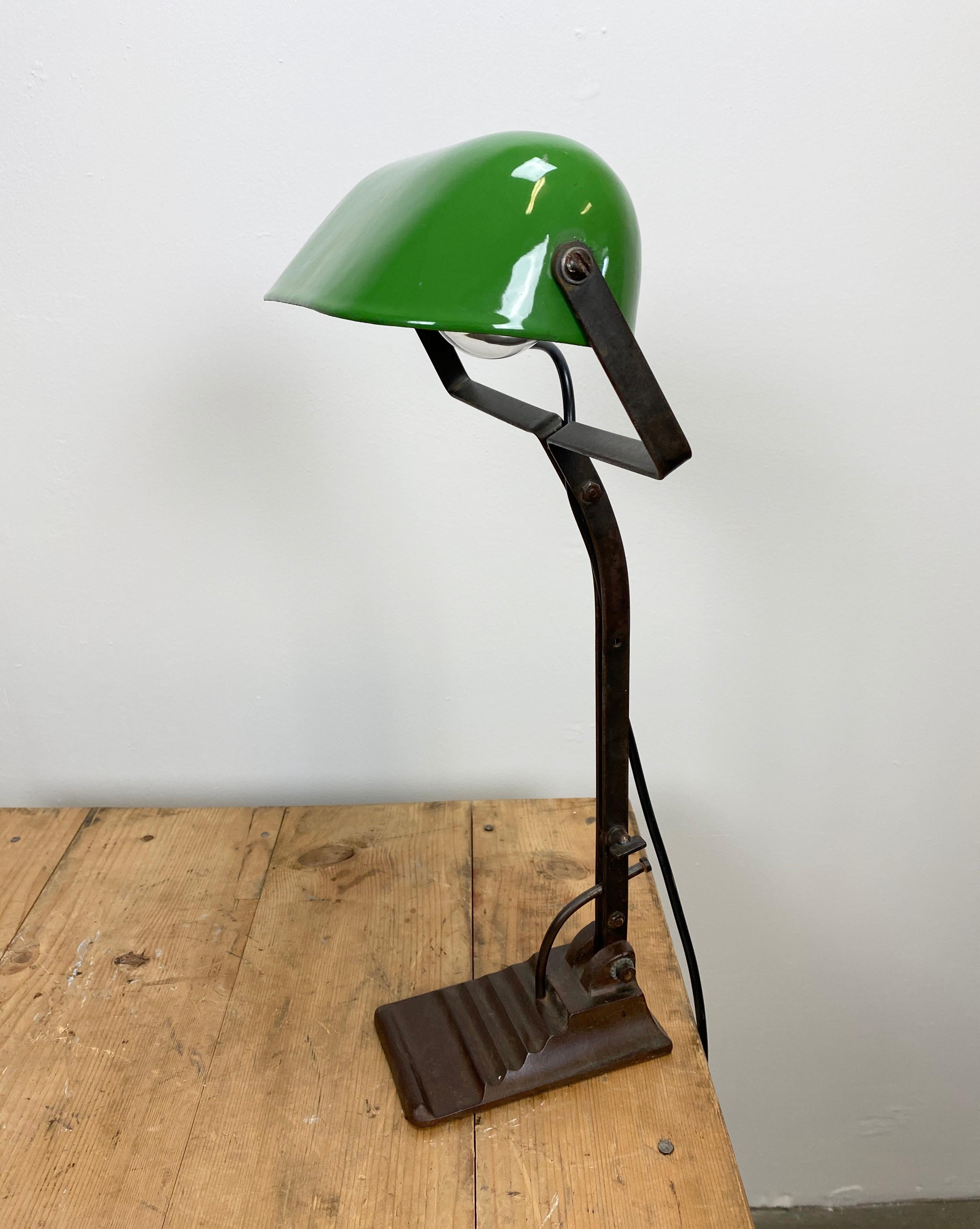 Vintage green table lamp from 1930s in Bauhaus style. Cast iron base. Green enameled iron shade. White enameled interior. The arm and shade are adjustable. Porcelain socket for E 27 light bulbs. Fully functional. Dimensions of the lampshade: 22cm x