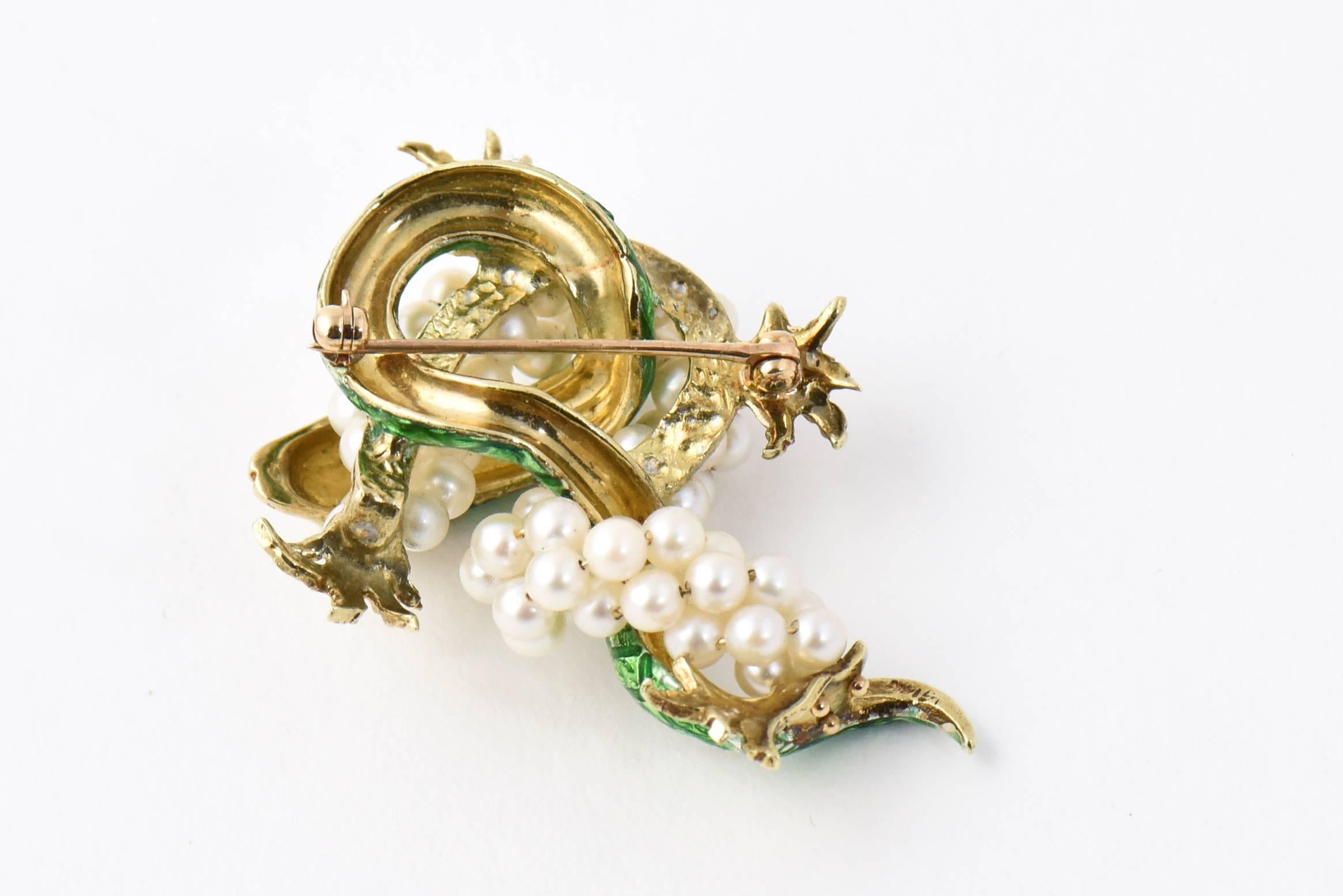 Beautiful green enamel and 14k yellow gold snake slithering through pearl and gold vines. 