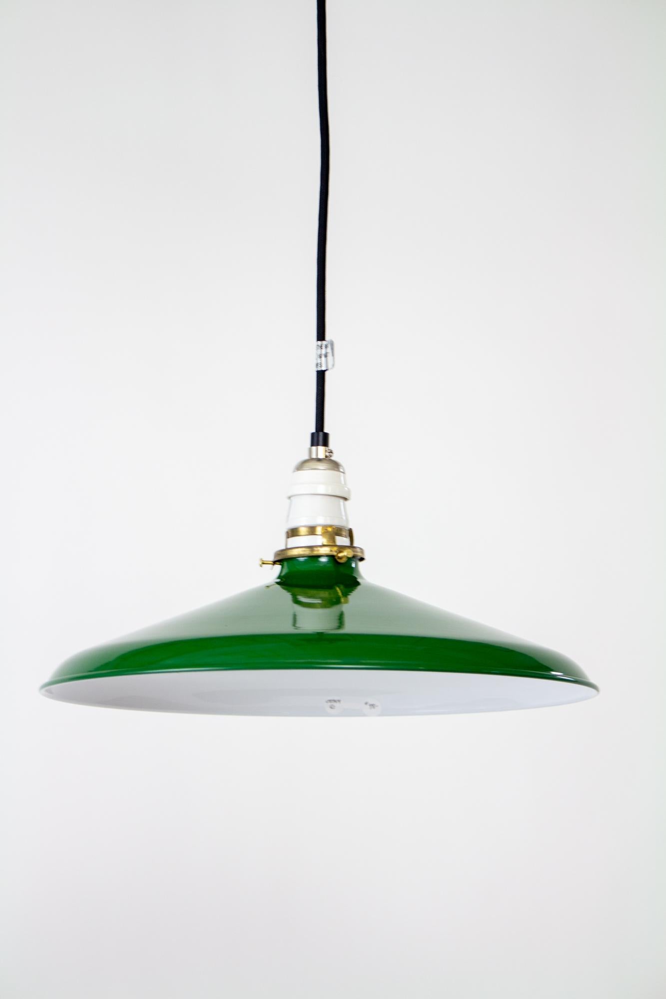 Green enamel industrial pendant. Black cord and canopy, porcelain antique style socket, antique clamp fitter and milk glass disk shade. Shown with Edison style bulb as a style suggestion, bulb is not included. Fixture is adjustable from 11