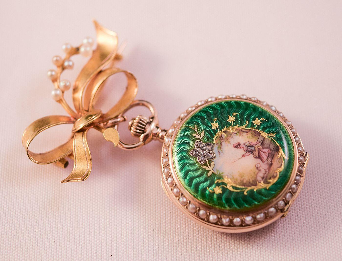 
An early gold,split pearl, rose cut diamonds and
 Beautiful Enamel fob watch.
Hunter case with top winding.
Cut and setting of the Rose cut diamonds prevents total carat weight estimation,
Lovely Green enamel  background on both sides with also