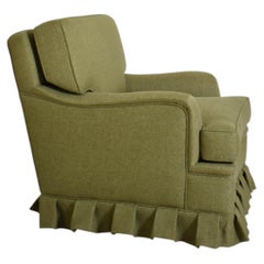Sillón verde de tela con flecos, de los años 60.