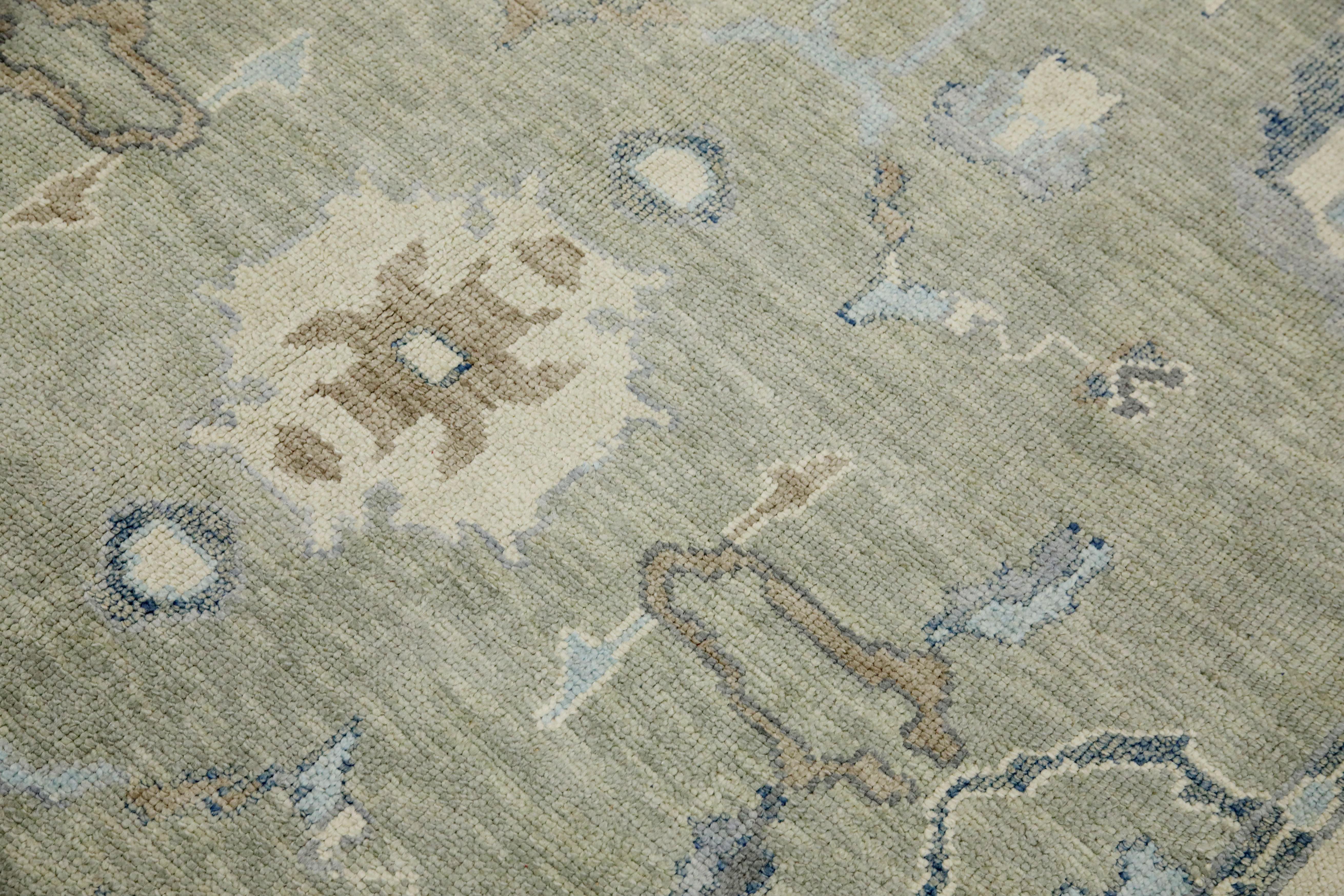 This modern Turkish Oushak rug is a stunning piece of art that has been handwoven using traditional techniques by skilled artisans. The rug features intricate patterns and a soft color palette that is achieved through the use of natural vegetable