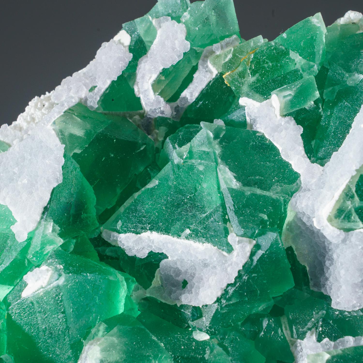 From Shanhua Pu Mine, Xianghualing, Hunan Province, China

Lustrous transparent green cubic fluorite crystals covered with colorless calcite crystals. The fluorite crystals are transparent and cubic crystal habit with complex corners of smaller