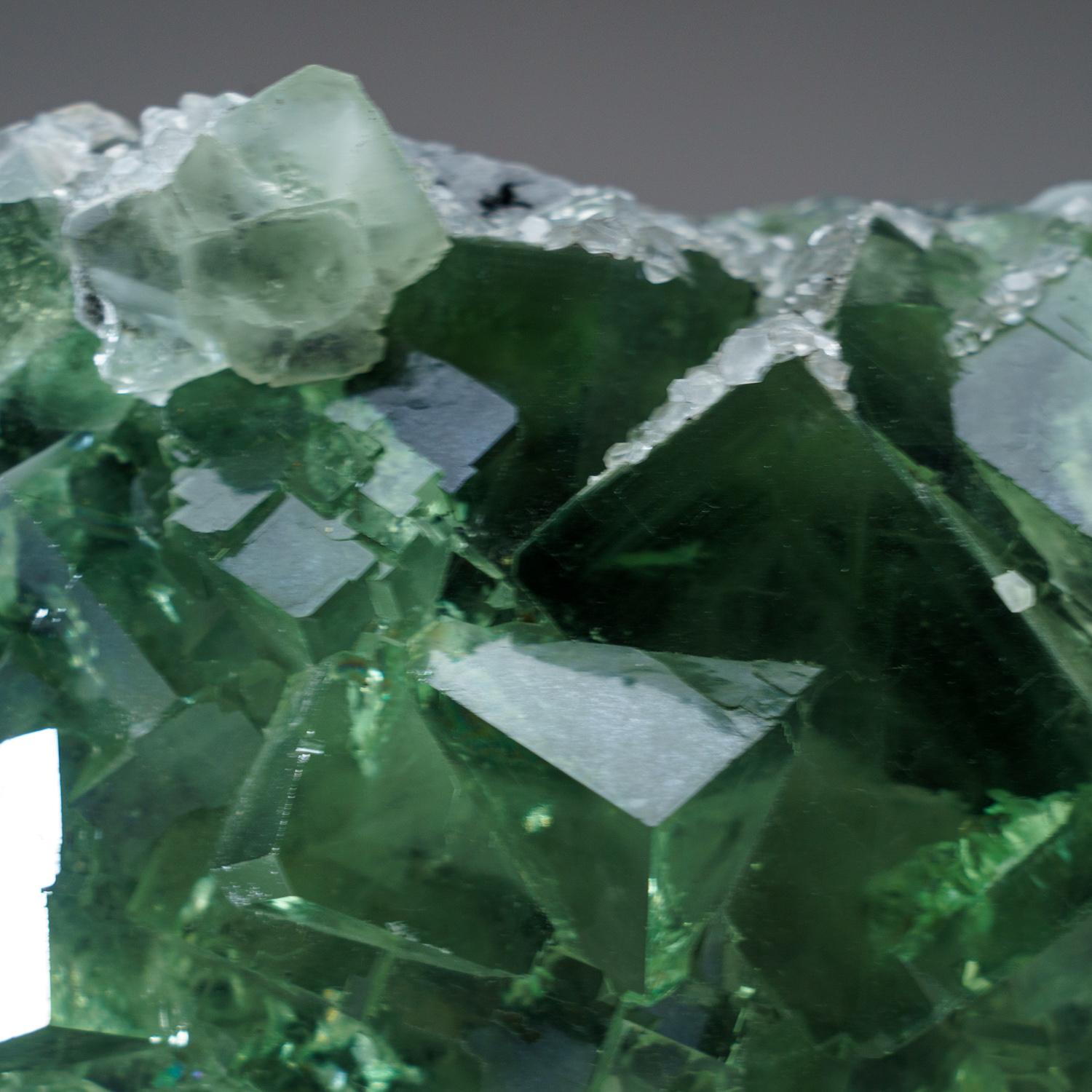 From Shanhua Pu Mine, Xianghualing, Hunan Province, China

Lustrous transparent green cubic fluorite crystals covered with colorless calcite crystals. The fluorite crystals are transparent and cubic crystal habit with complex corners of smaller
