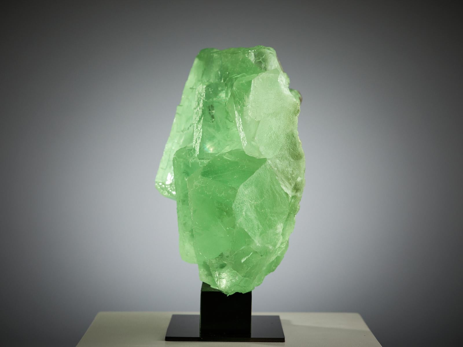 A stunning specimen of green fluorite from China, formed by large intergrown cubes of different sizes, creating a beautiful and sculptural shape. The central crystal is especially striking, with sharp edges and perfect geometry.

The colour is a