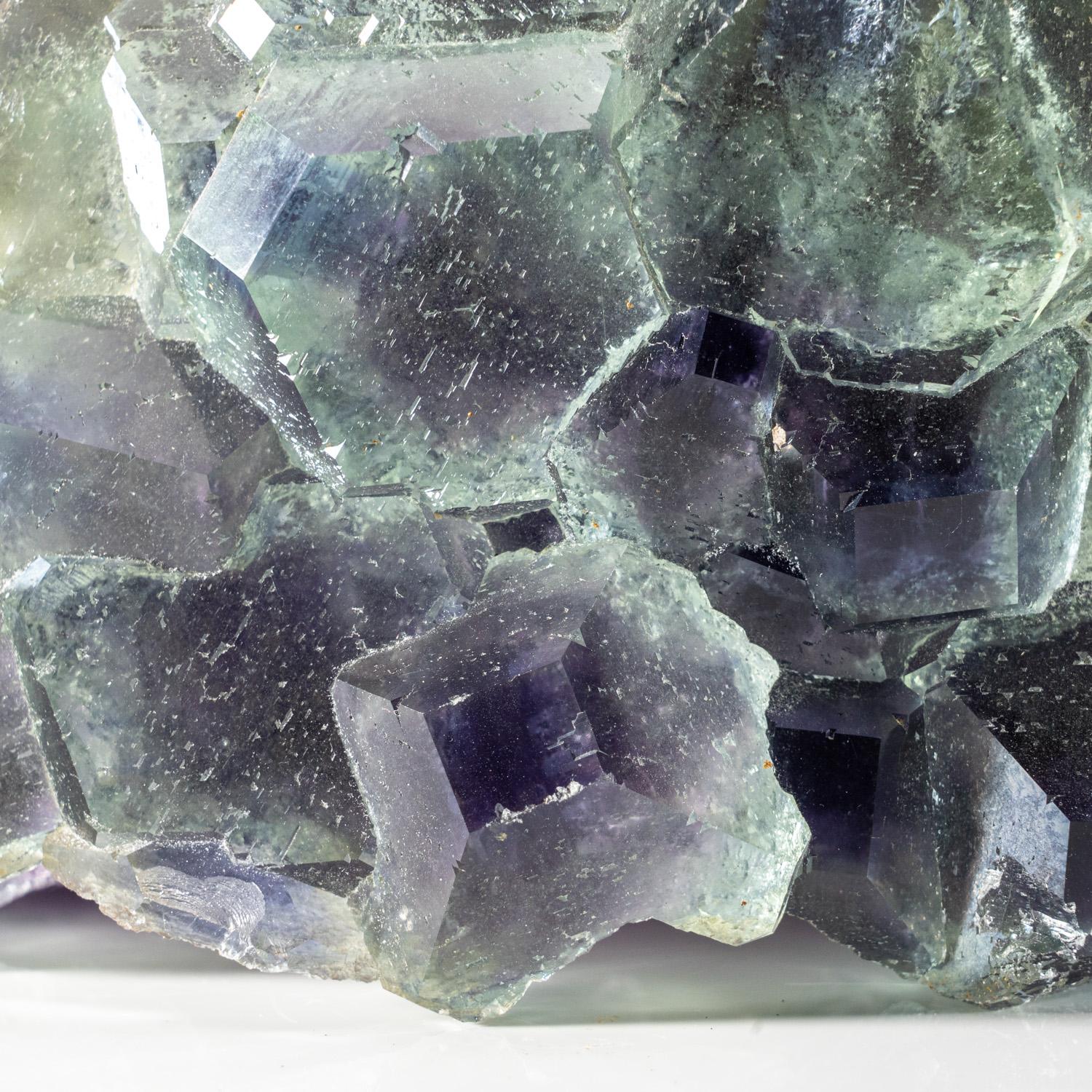 From Yaogangxian Mine, Nanling Mountains, Hunan Province, China  

Transparent cluster of light green  blue fluorite crystals with glassy crystal surfaces gem green core with blue phantom zoning around the crystal terminations. The fluorite crystals