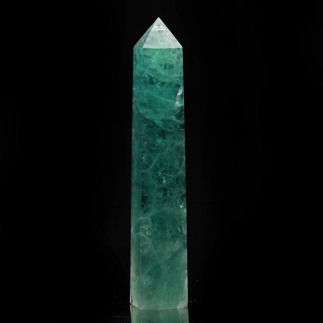 This mesmerizingly swirled, deeply pigmented green fluorite tower from China has been hand-carved out of excellent quality crystal and polished to a brilliant luster. It displays beautiful translucency, especially when backlit, bringing alive the