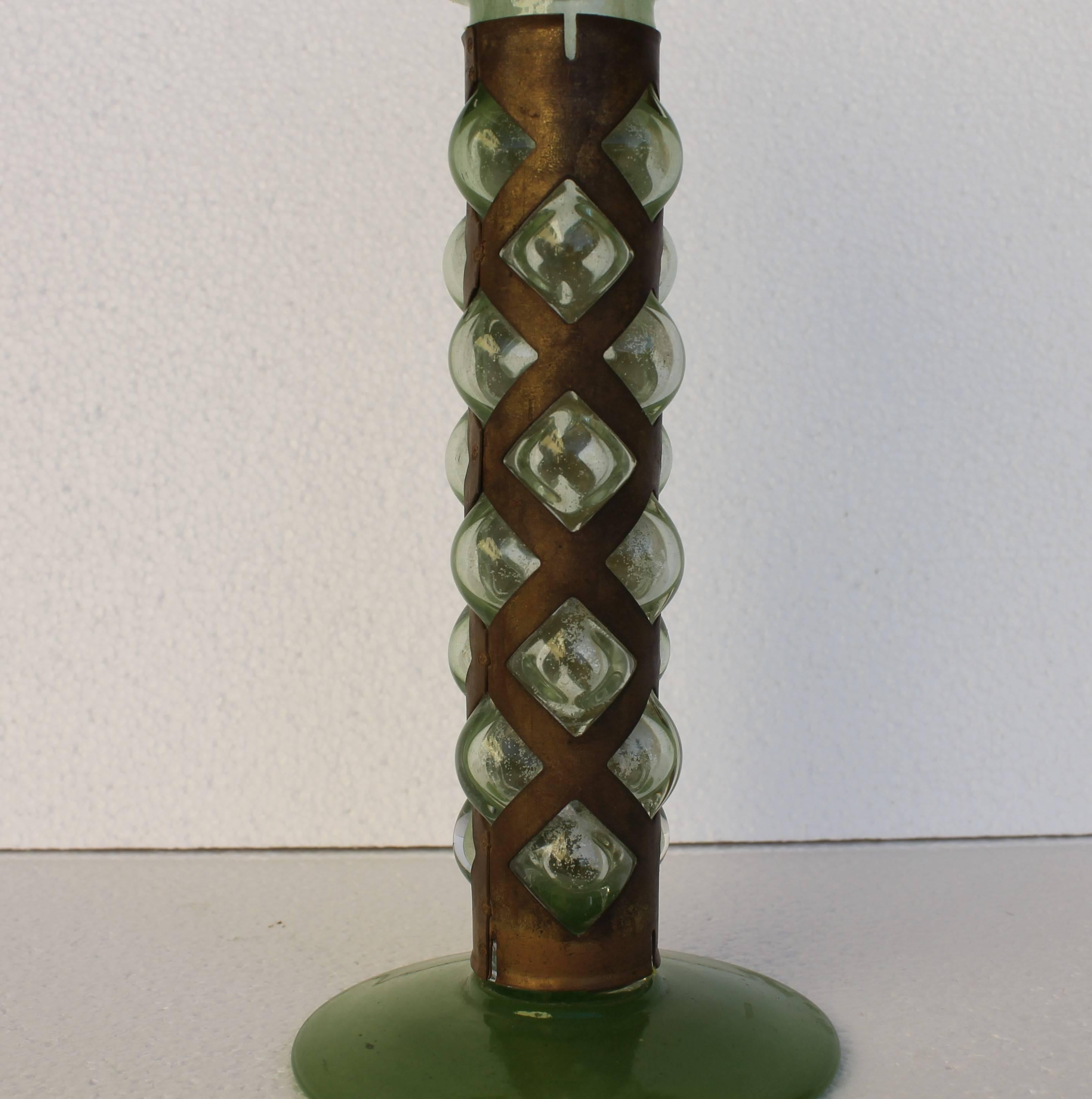 Green glass and brass cup, in the manner of VIENNESE SECESSION period.

Green glass cup with stem wrapped by a brass cover from which emerge green glass bubbles.
 
