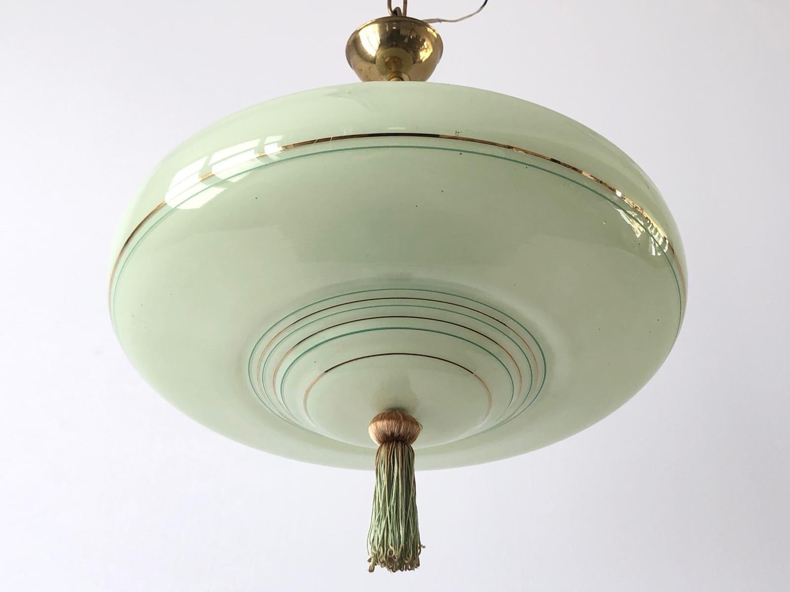 Green Glass Art Deco Style Ceiling Lamp, 1950s, Germany

This lamp works with E27 light bulb.

Measurements: 
Height: 38 cm
Shade diameter and height: 39 and 11 cm


