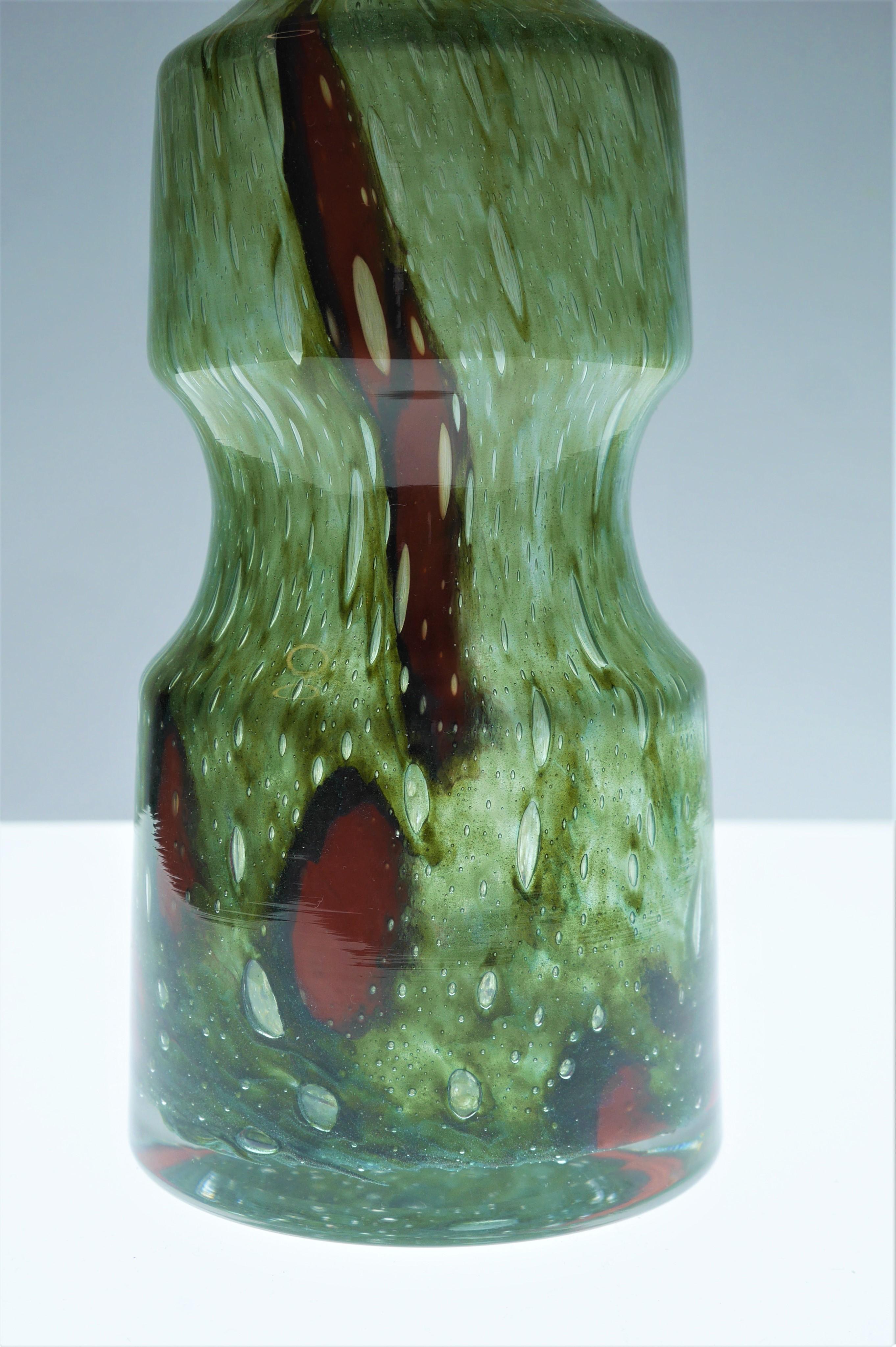 Stunning, iridescent green glass 'Flora' vase with red and black details. Made by Frantisek Koudelka for Prachen, Czech Republic, 1970s. 
From the Mid-Century but has a Bohemian design with air bubbles integrated into the colour flow. František