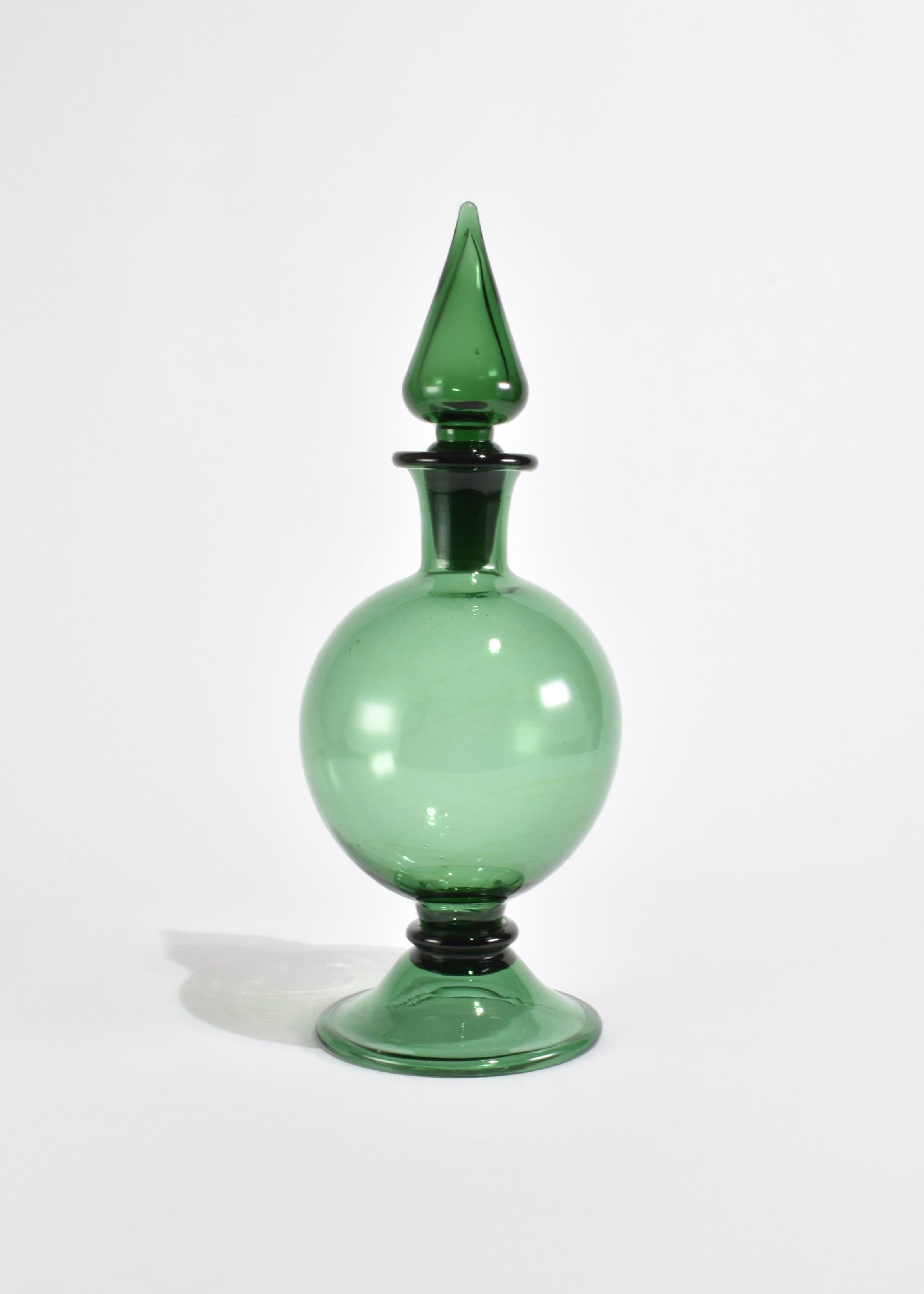 Beautiful hand blown glass decanter in green with a pointed glass stopper. Made in Italy.