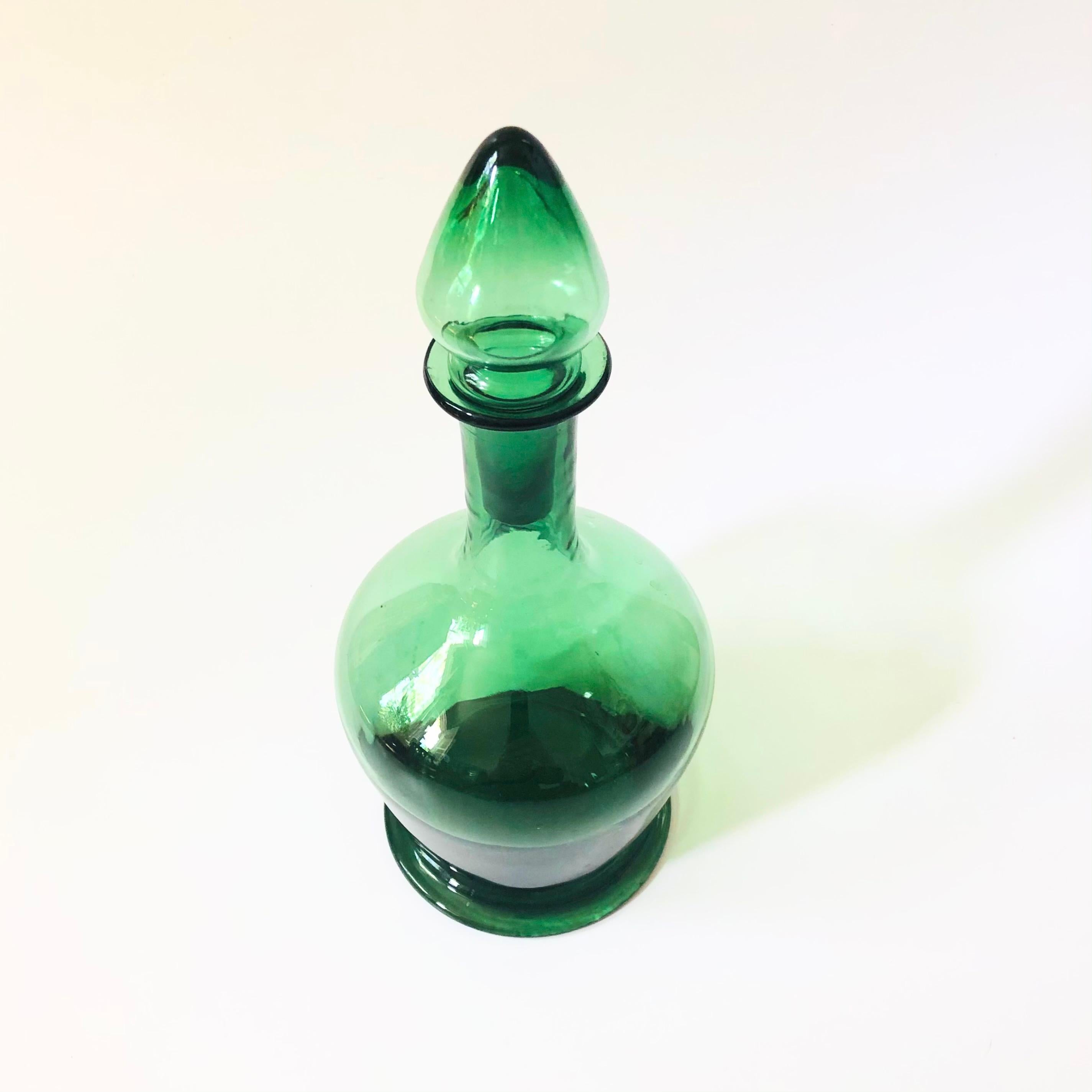 A vintage glass decanter. Beautiful green color to the glass.

