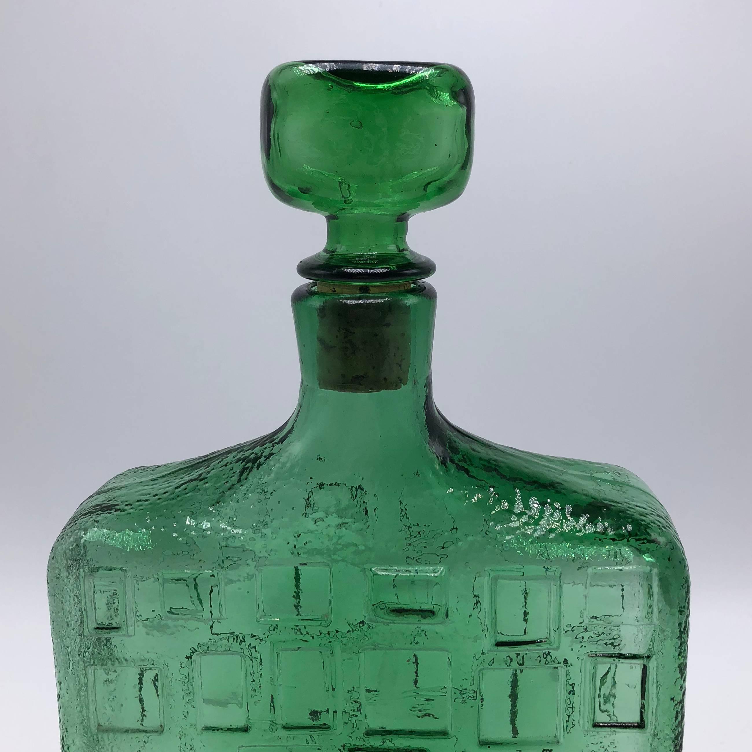 Green glass decanter with stopper, circa 1970.
  