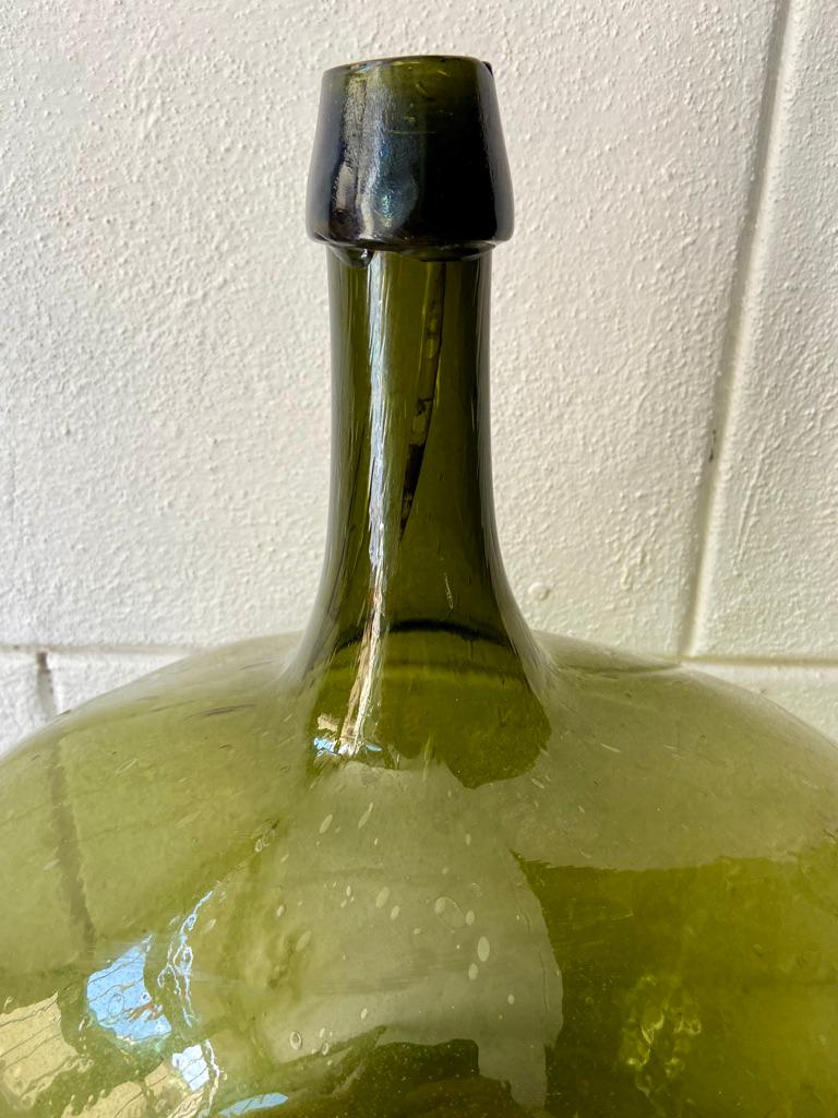 Green glass demijohn from Puebla, Mexico 1920's.