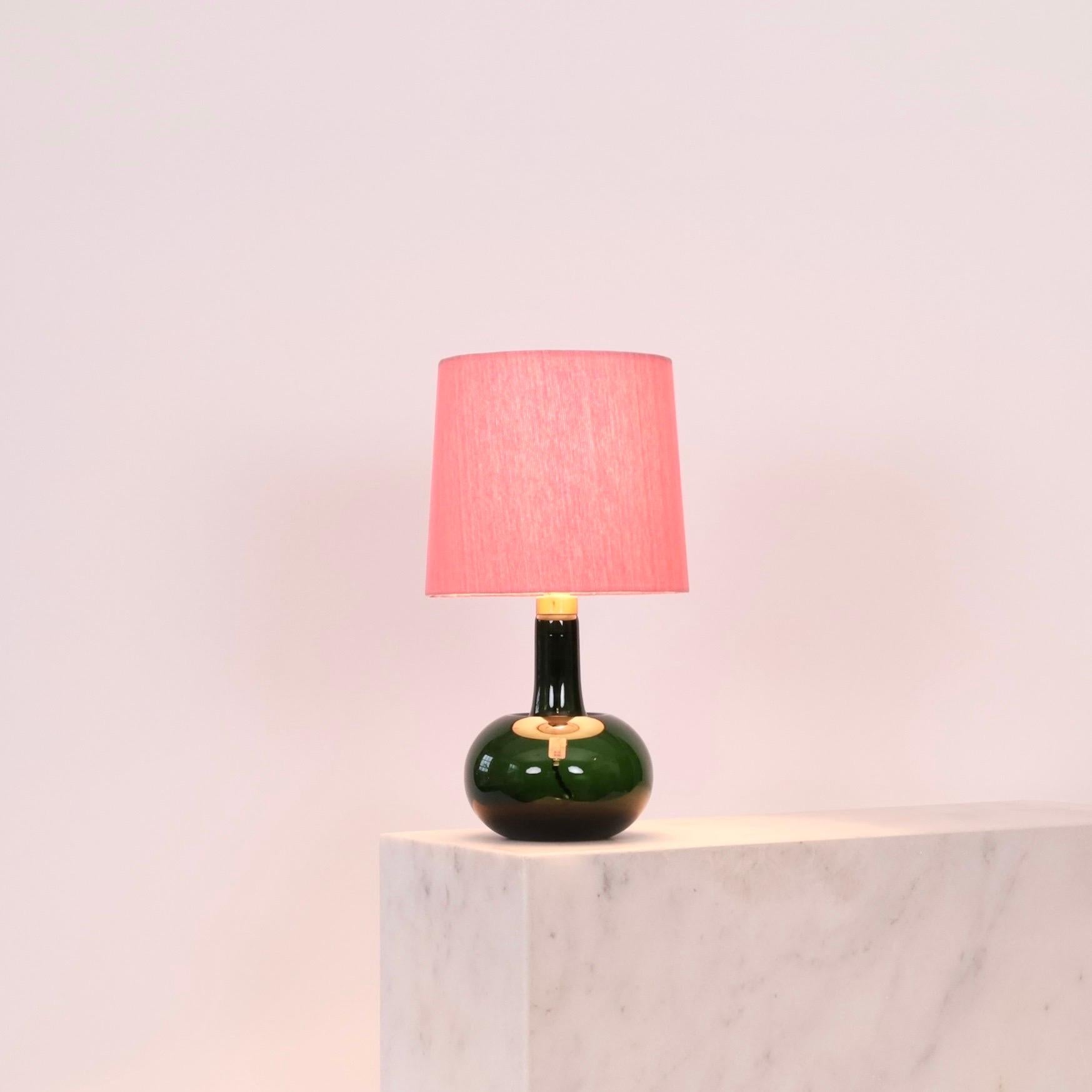 Lampe de bureau verte conçue par Michael Bang pour le danois Holmegaard Glasværk en 1975, dotée d'un nouvel abat-jour en textile artisanal de Majorque. Une attribution colorée à un intérieur moderne.

* Lampe de table en verre vert avec un col en