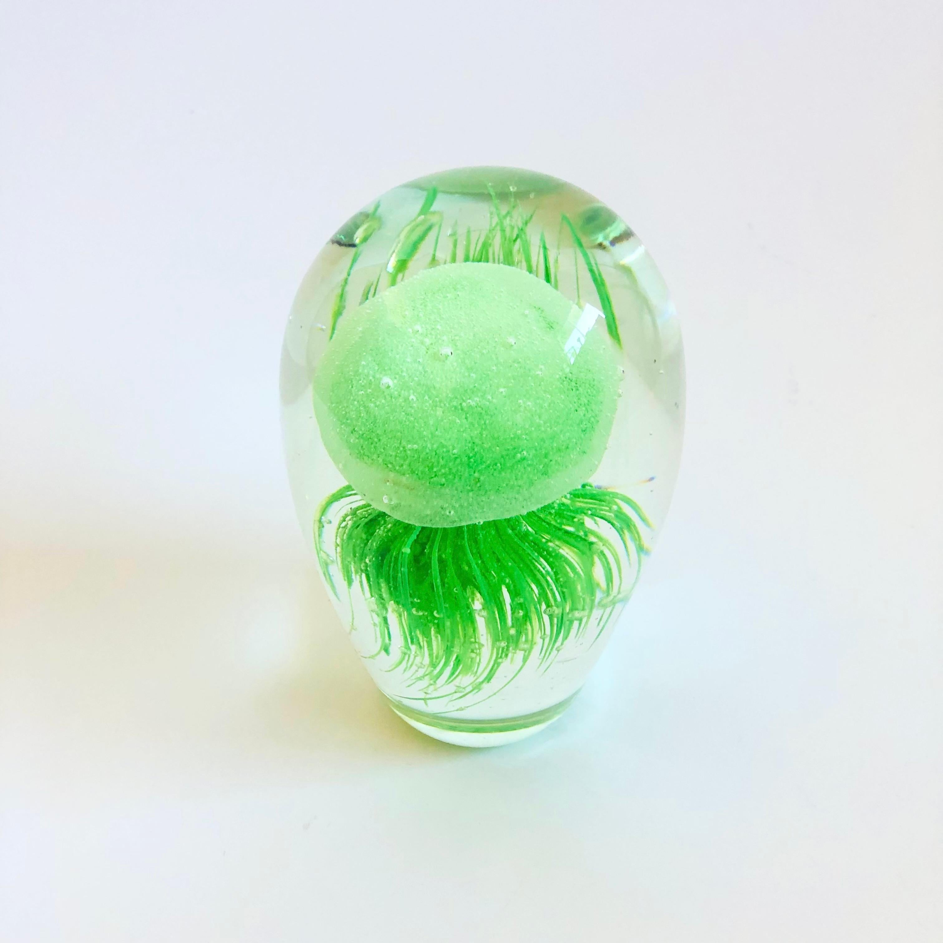 A vintage art glass jellyfish. Clear with a vibrant green jellyfish in the center. A great sculptural accent with beautiful detailing formed to create the details of the jellyfish.

