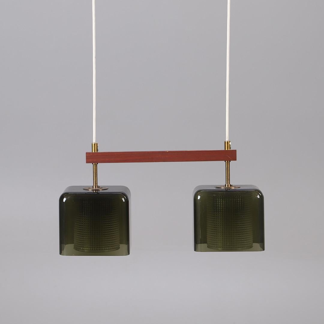 Square shaped green glass and clear glass (inside) both connected with a teak pole. Designed in the 1960s by Carl Fagerlund for  Orrefors Glassworks in Sweden. Light grey tinted glass outer cup with a cylinder internal diffuser in clear pressed